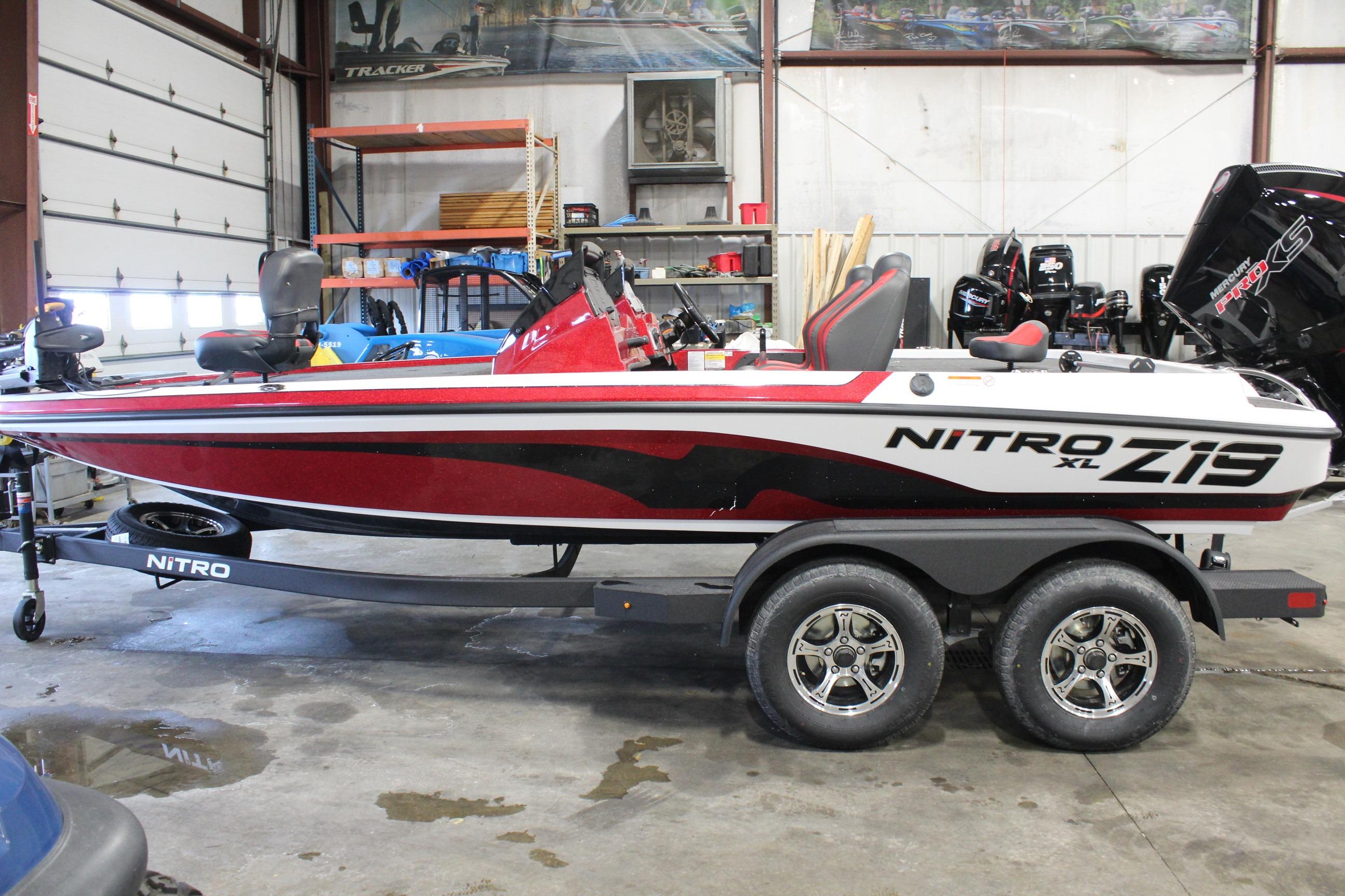 2026 Nitro Z19 XL Pro boat in a garage, red and white design, on a trailer.