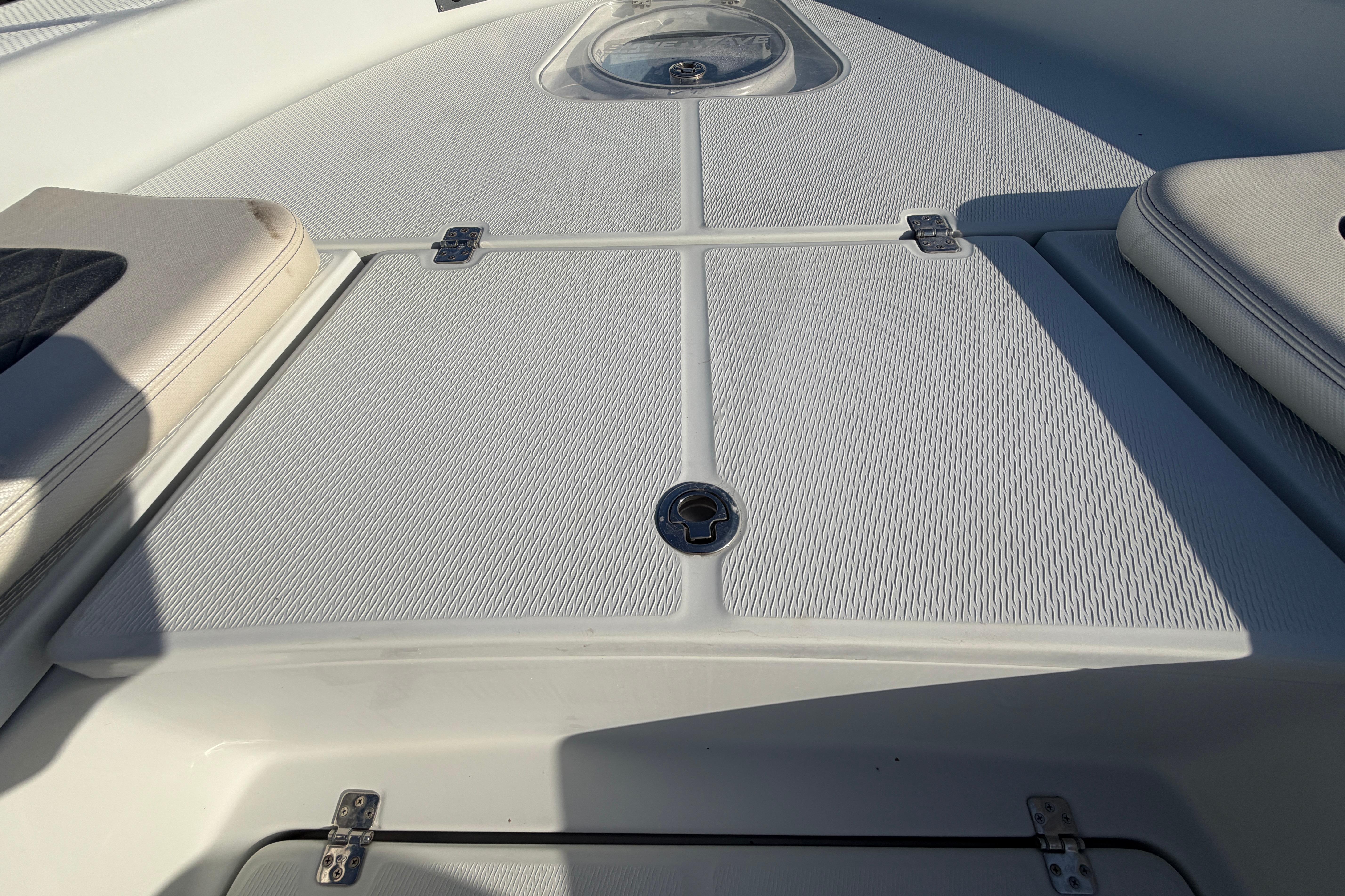 2018 Blue Wave 2800 Pure Hybrid boat deck with storage compartments and cushioned seating.