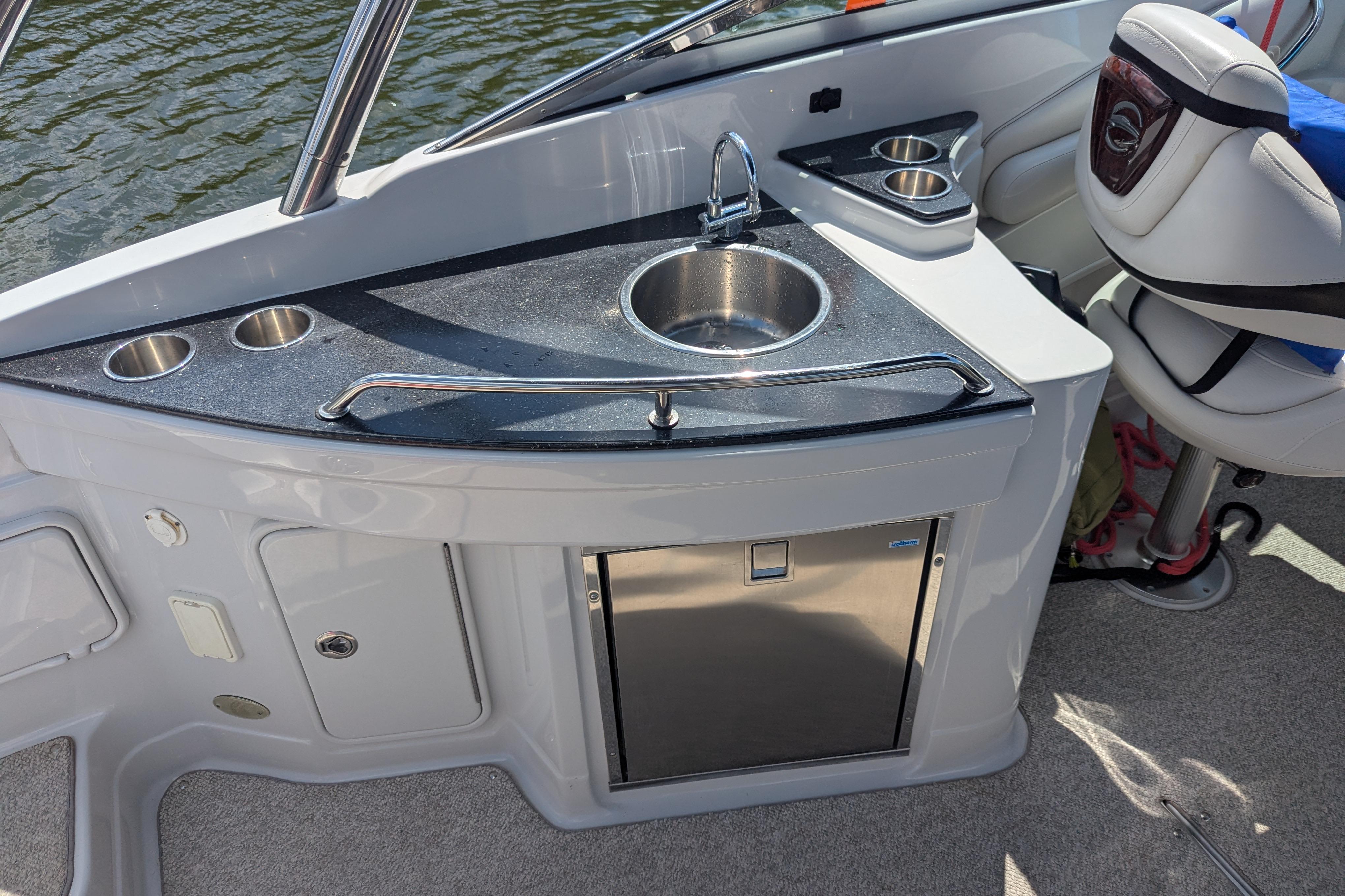 2008 Crownline 300 LS boat interior with sink and seating area.