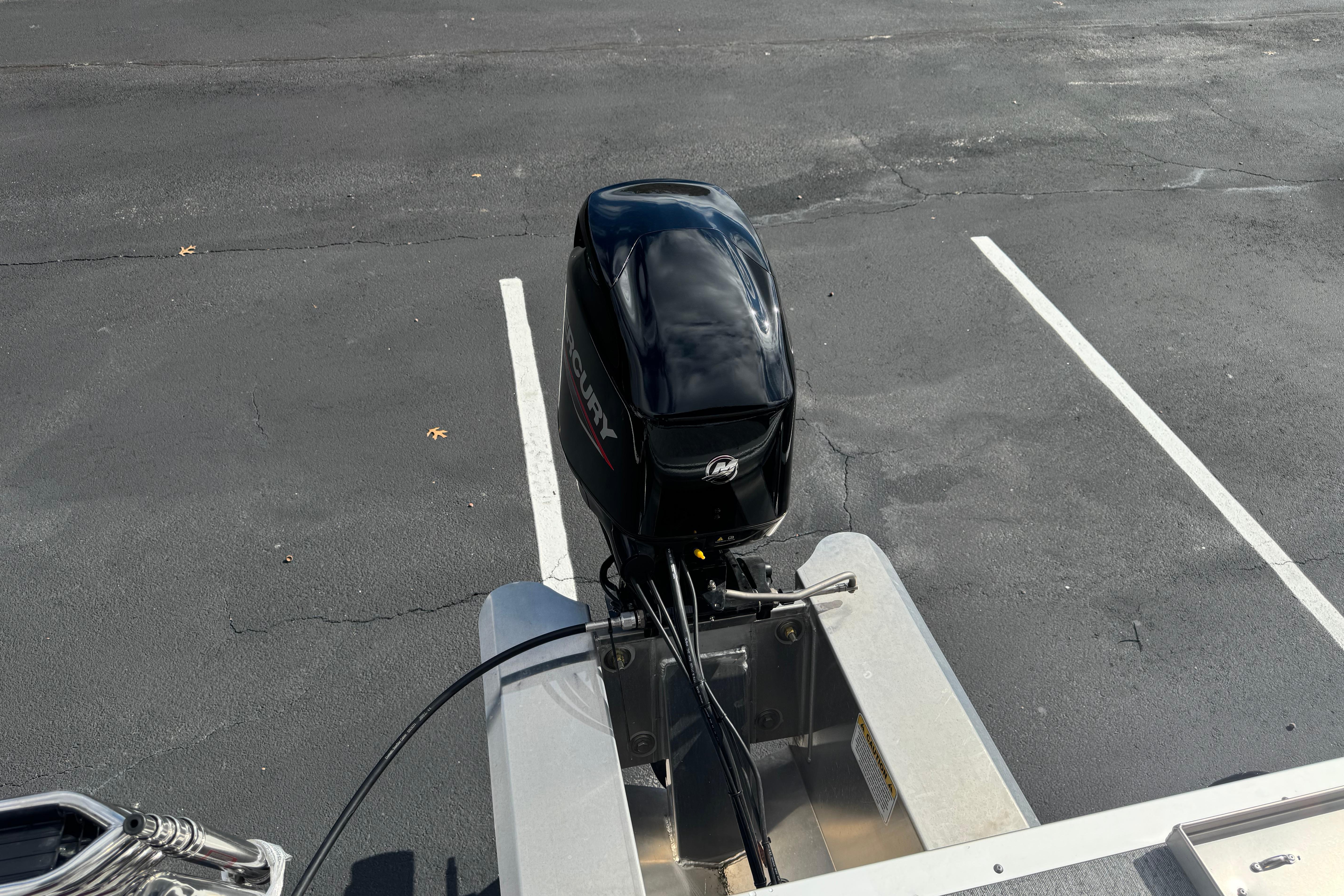 2026 Sun Tracker Bass Buggy 16 XL Select with Mercury outboard motor in parking lot.