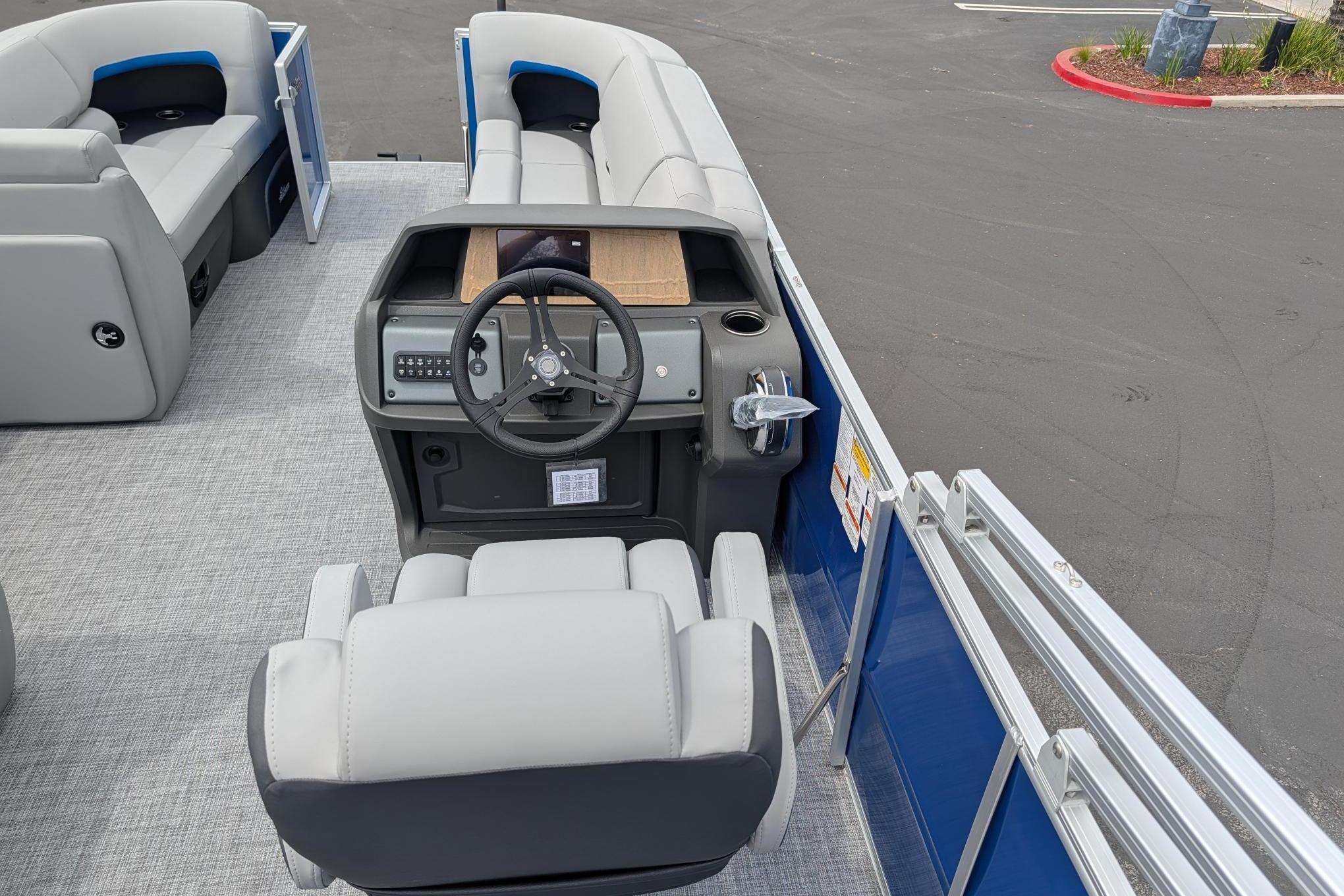 2026 Sun Tracker Party Barge 20 DLX interior with steering console and seating.