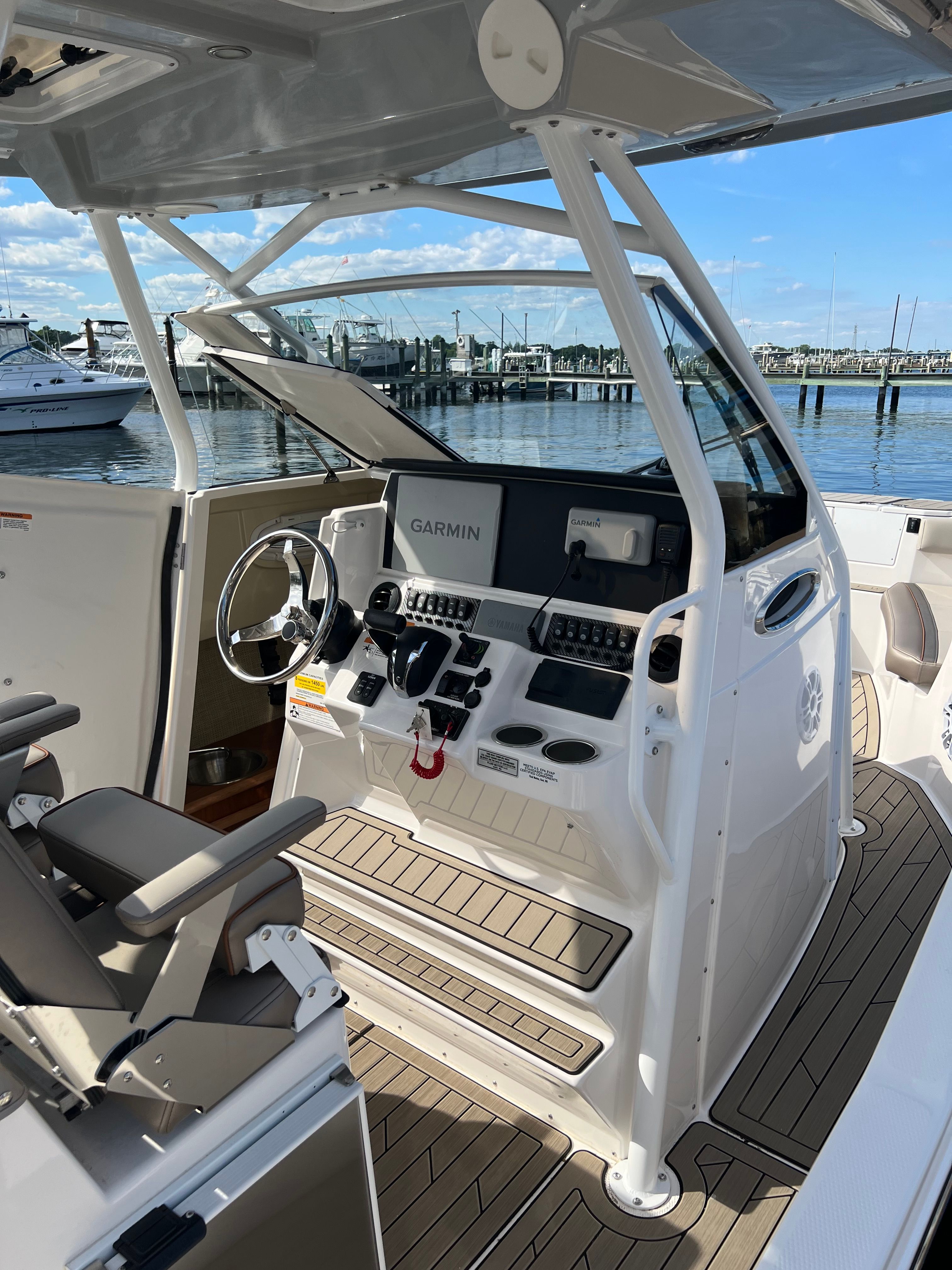 The image shows the cockpit of a 2022 Cutwater C-24 CW boat with modern equipment.