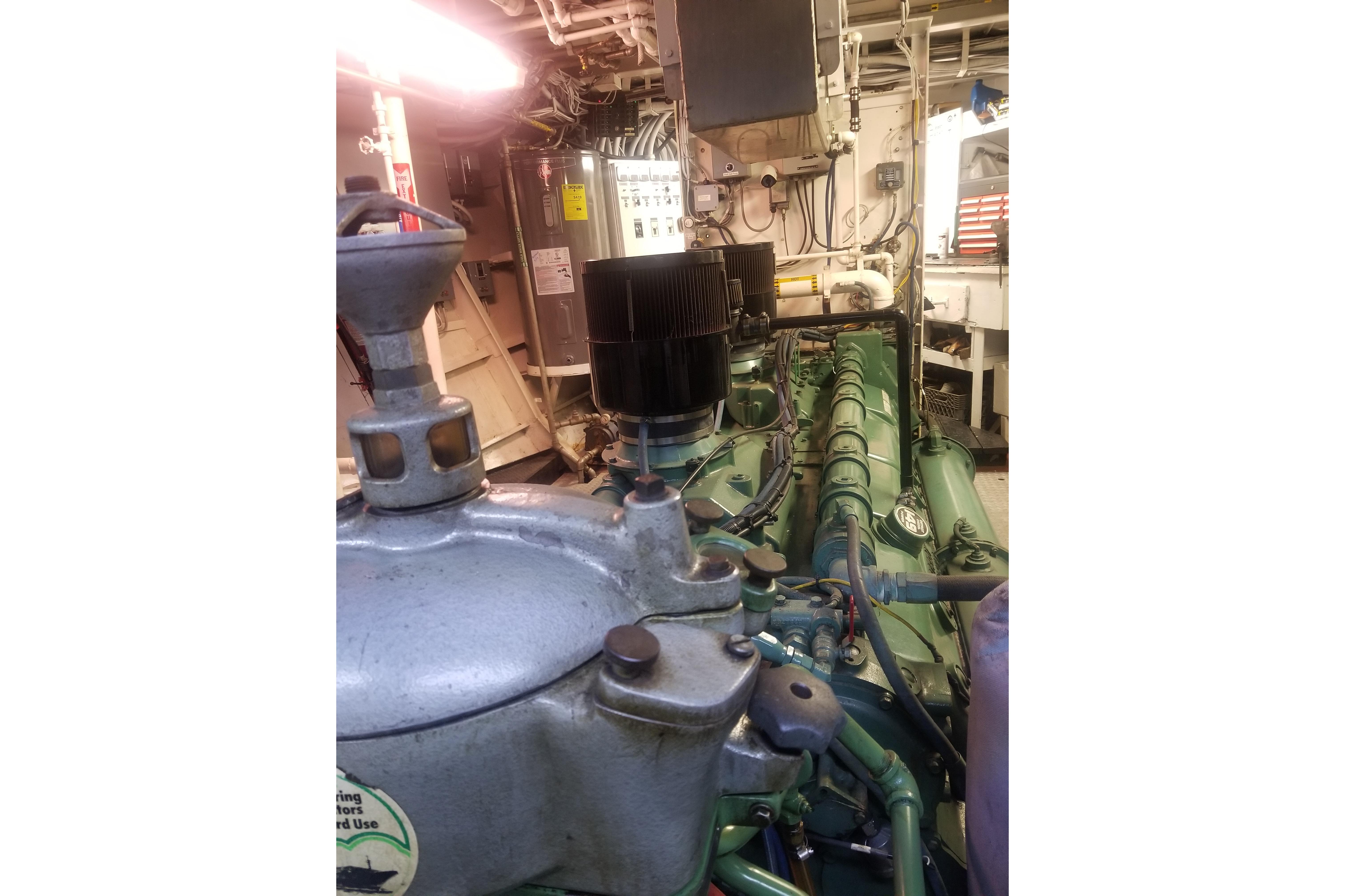 Engine room of a 1974 Custom Steel Cannery Tender, showcasing machinery and components.