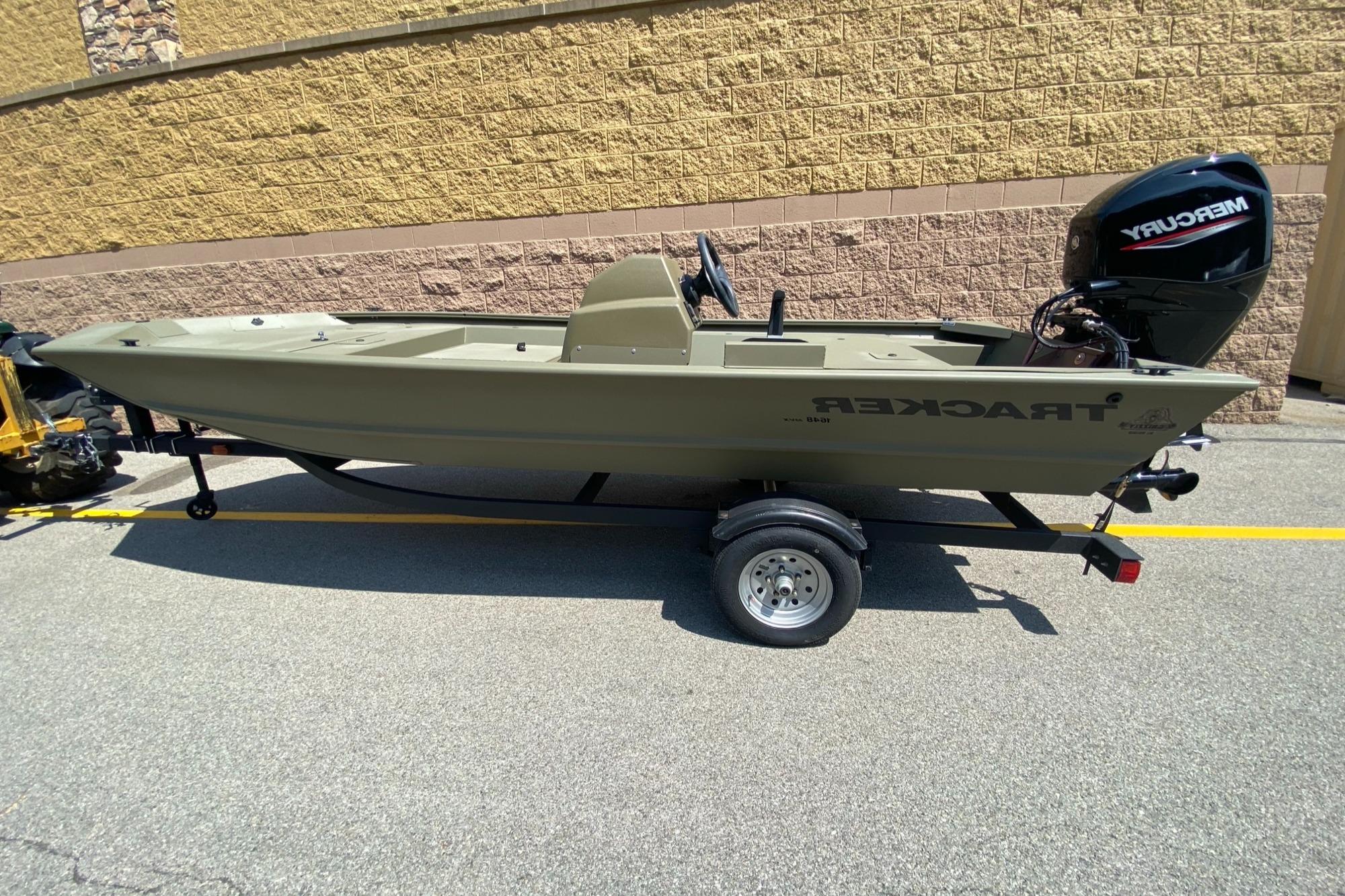 2024 Tracker Grizzly 1648 SC boat on trailer with Mercury outboard motor.