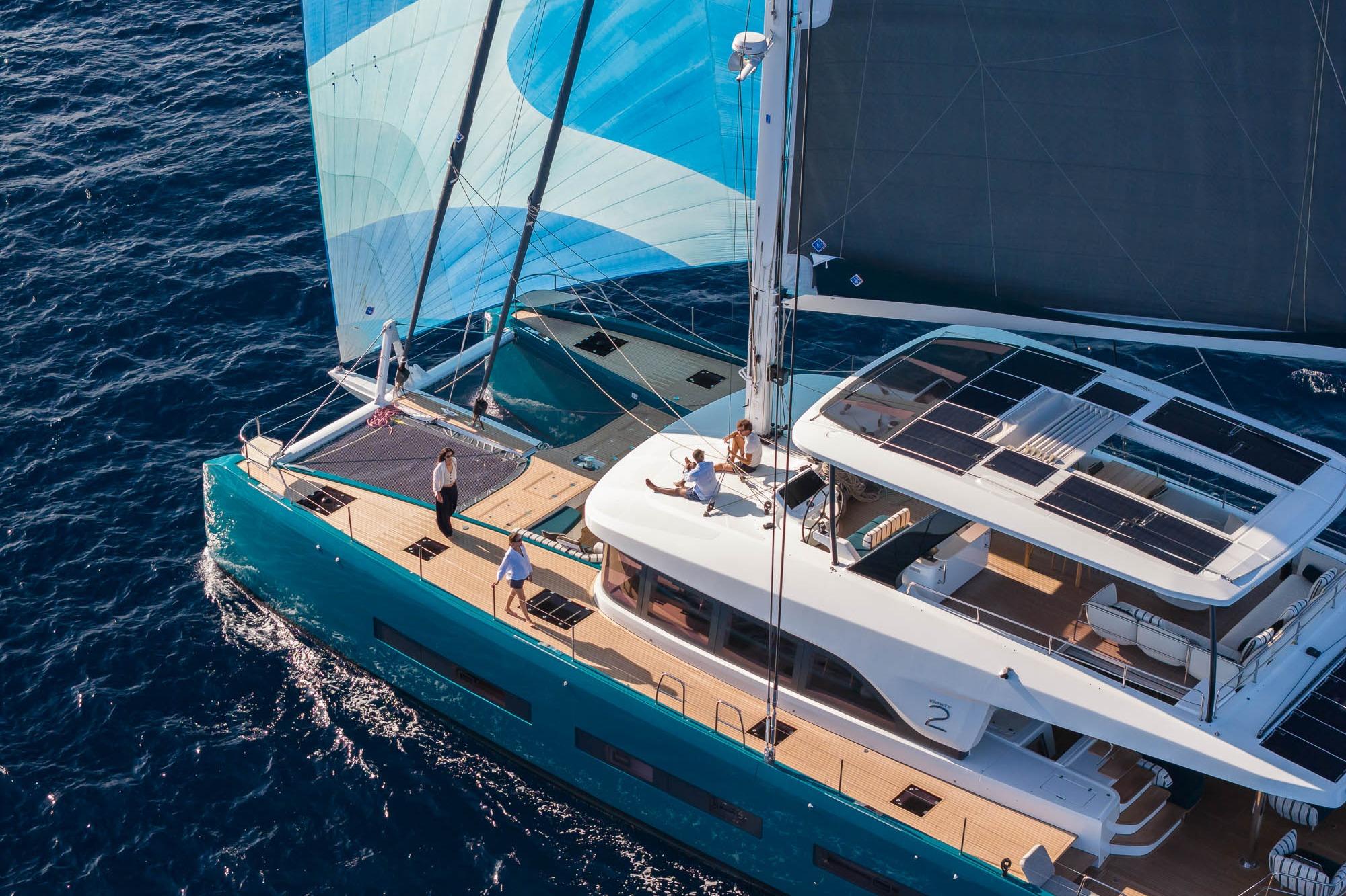 2026 Lagoon Eighty 2 yacht sailing on open sea with people on deck.