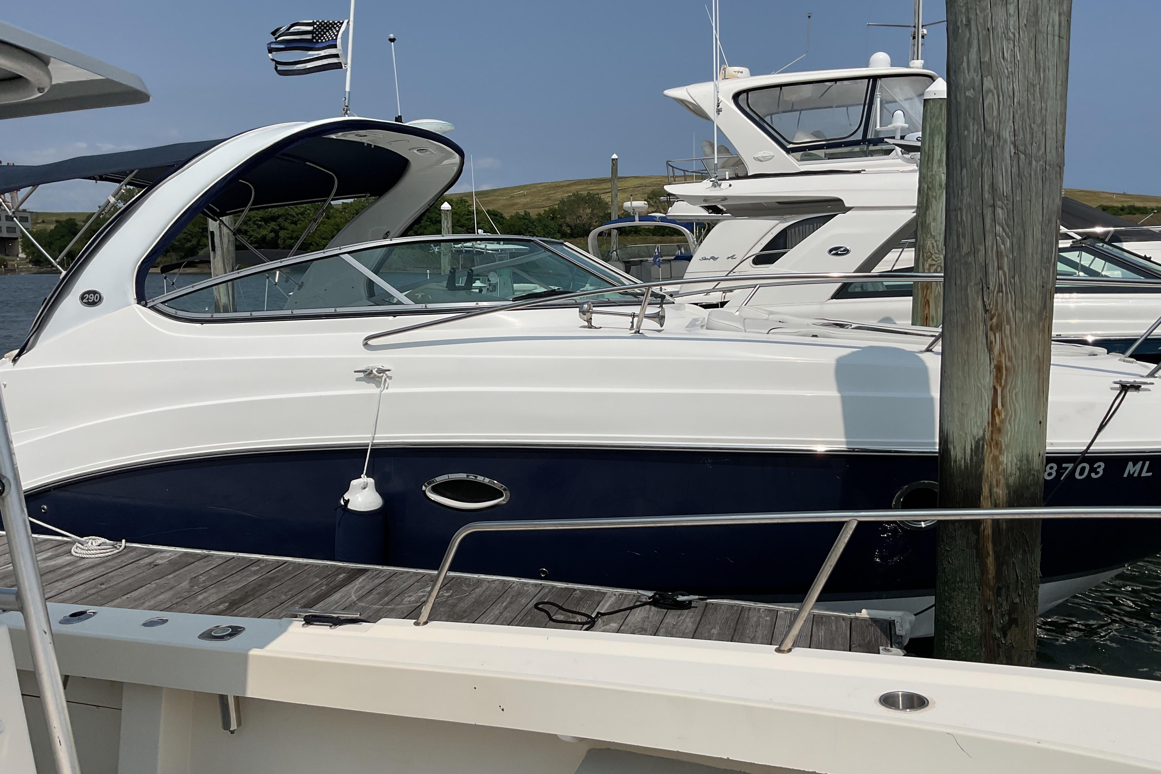 2013 Rinker 290 Express Cruiser docked at marina, side view.