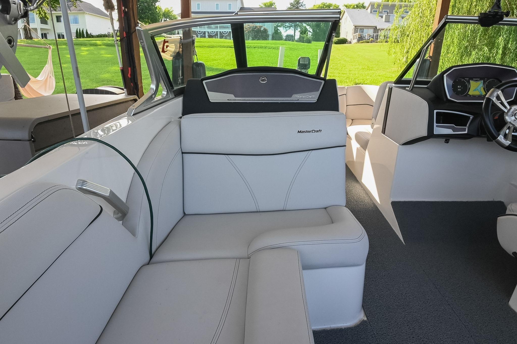 2018 MasterCraft X23 boat interior with white seating and modern dashboard.