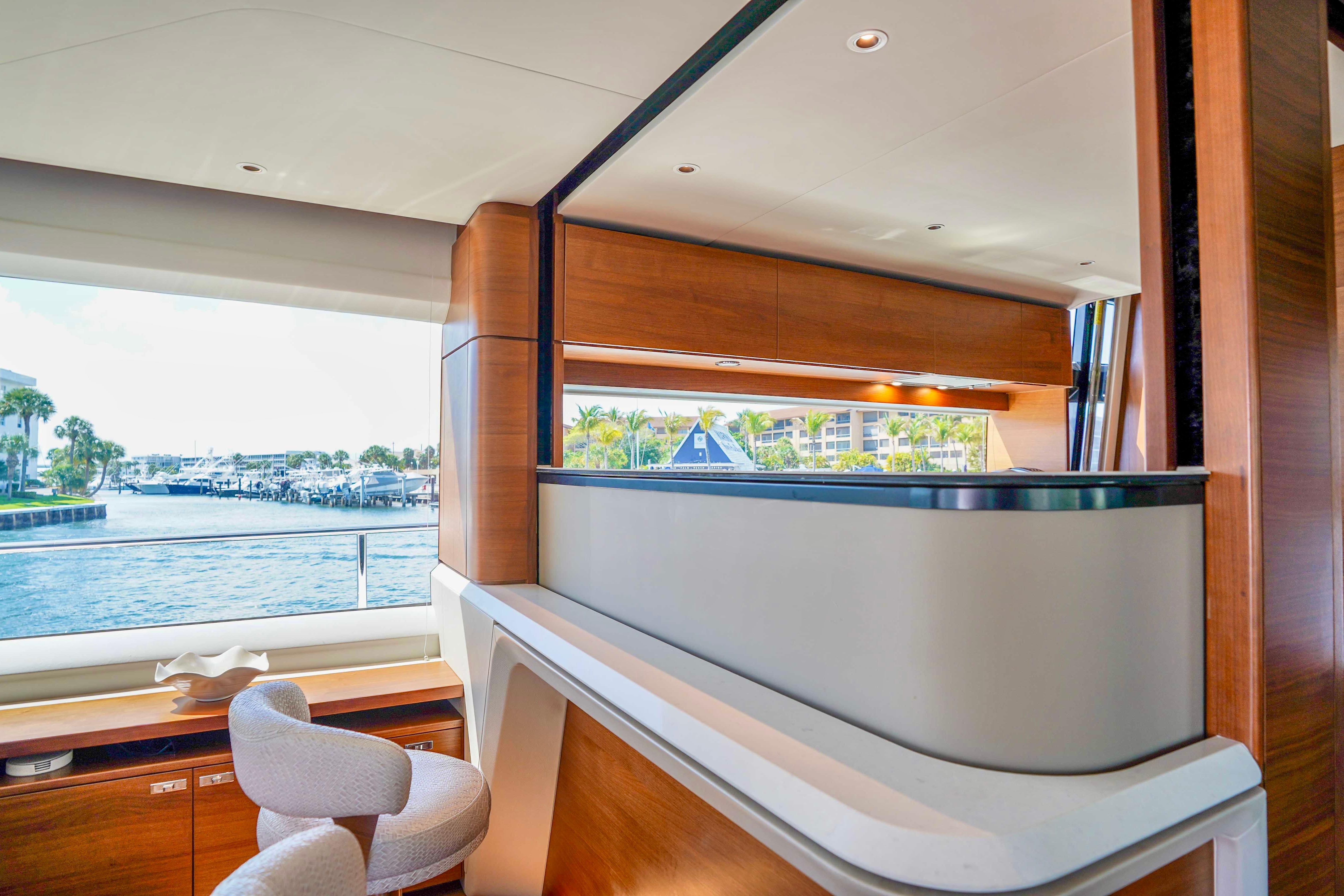 Luxurious interior of 2021 Princess Y85 yacht with waterfront view and elegant furnishings.