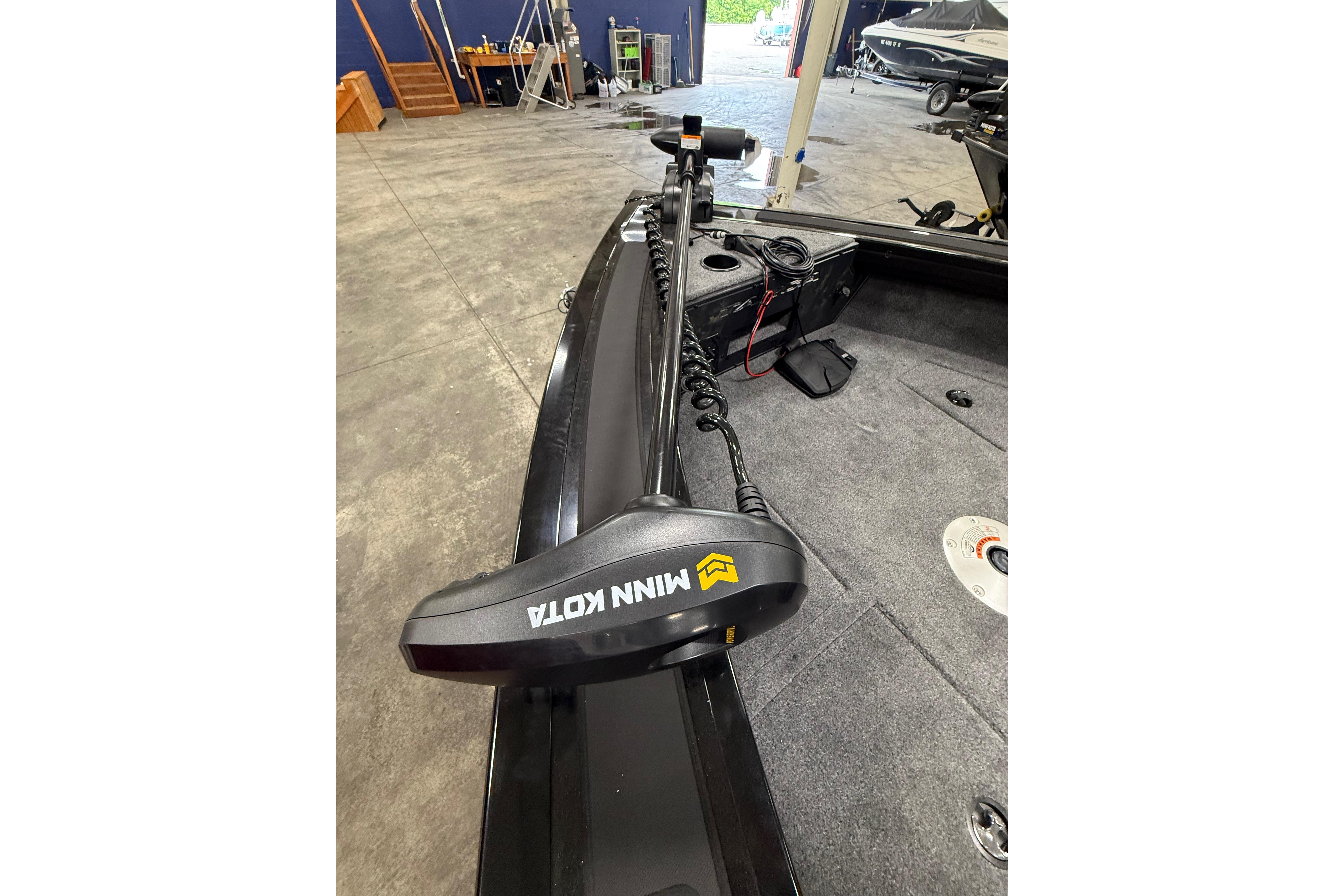 2026 Tracker Targa V-19 WT boat with Minn Kota trolling motor in a showroom.