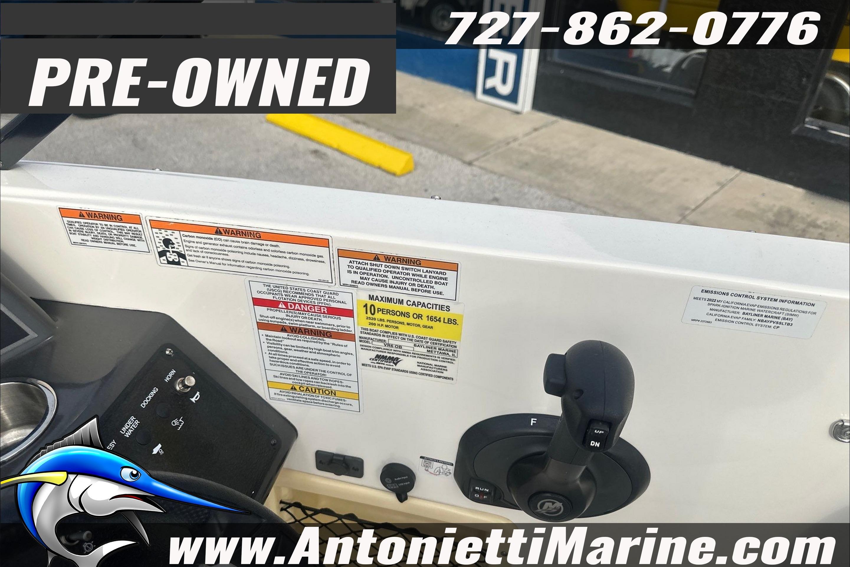 Pre-owned 2022 Bayliner VR6 Bowrider OB dashboard with control panel and warning labels.