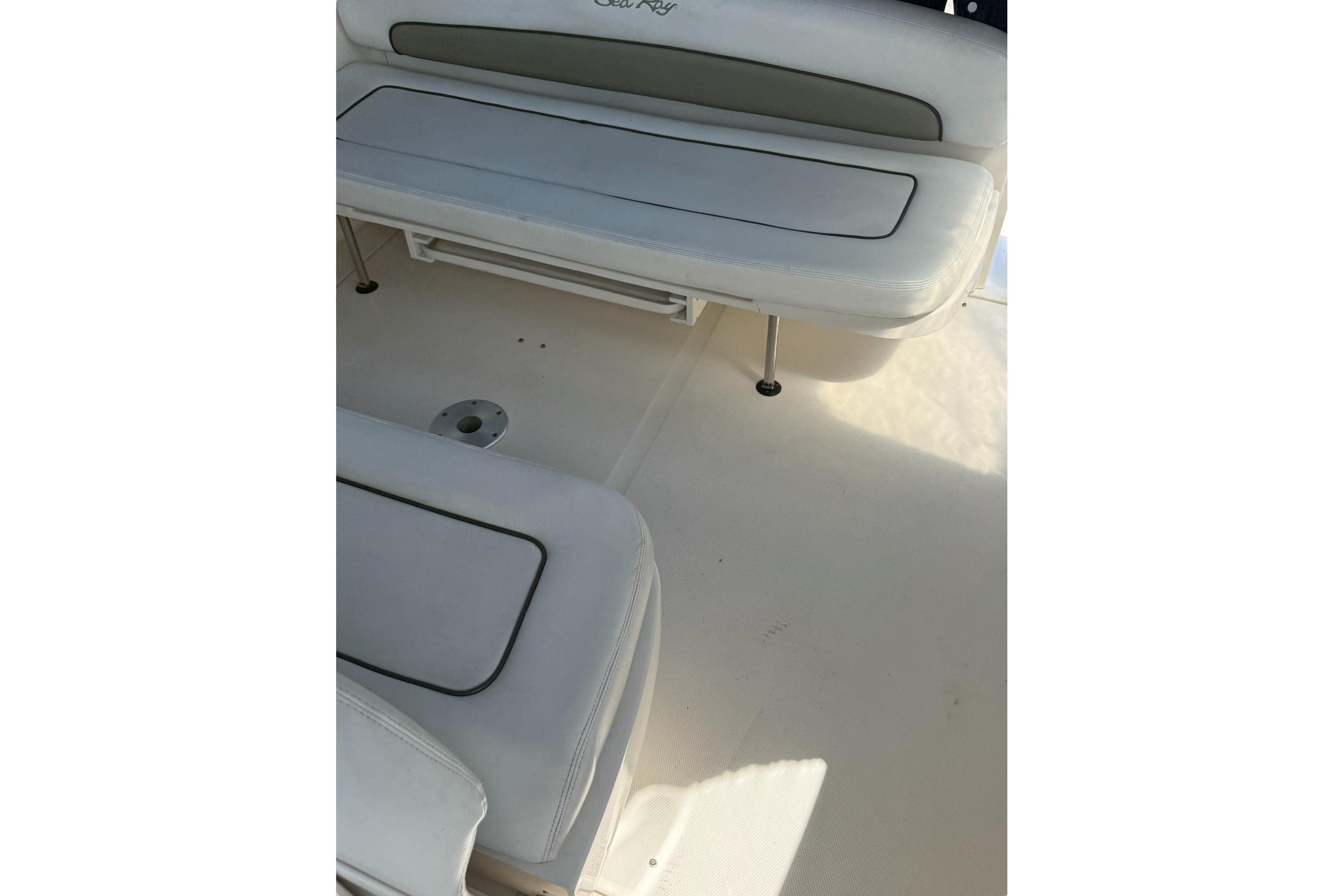 2006 Sea Ray 300 Sundancer boat interior with white cushioned seating.