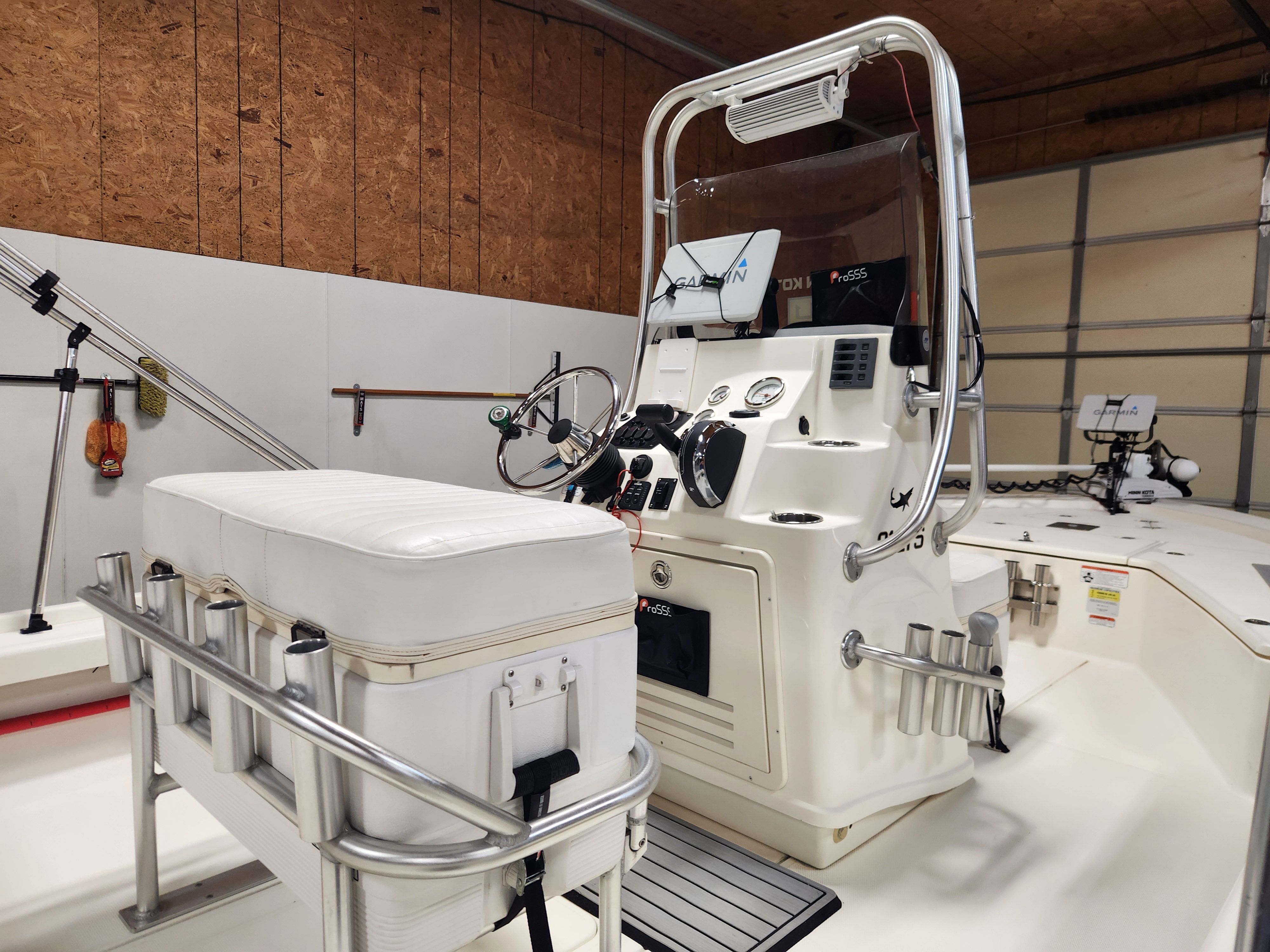Interior view of a 2014 Mako 21 LTS with helm console and bench seating.