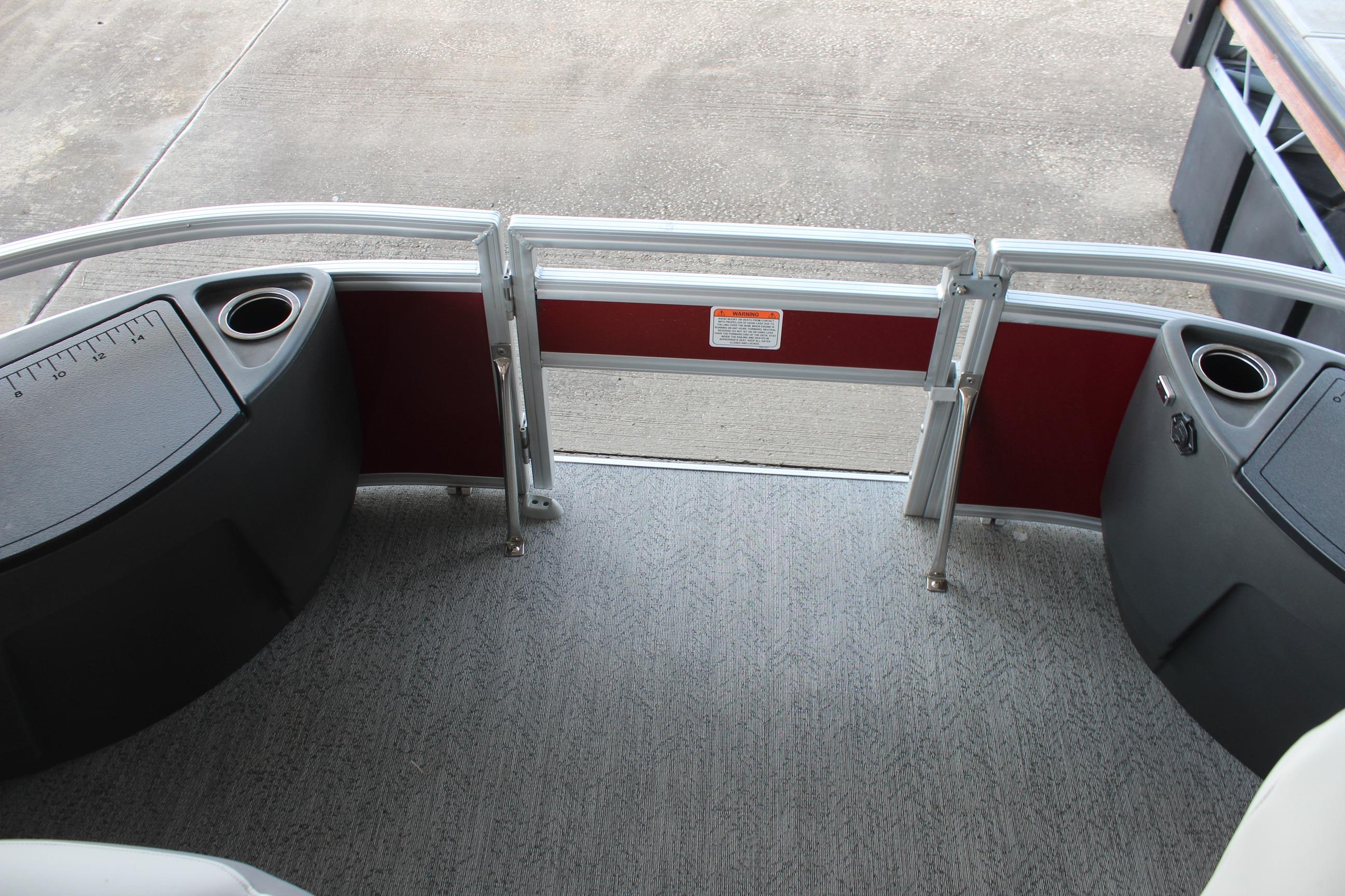 2026 Sun Tracker Bass Buggy 18 DLX pontoon boat deck with cup holders and railing.