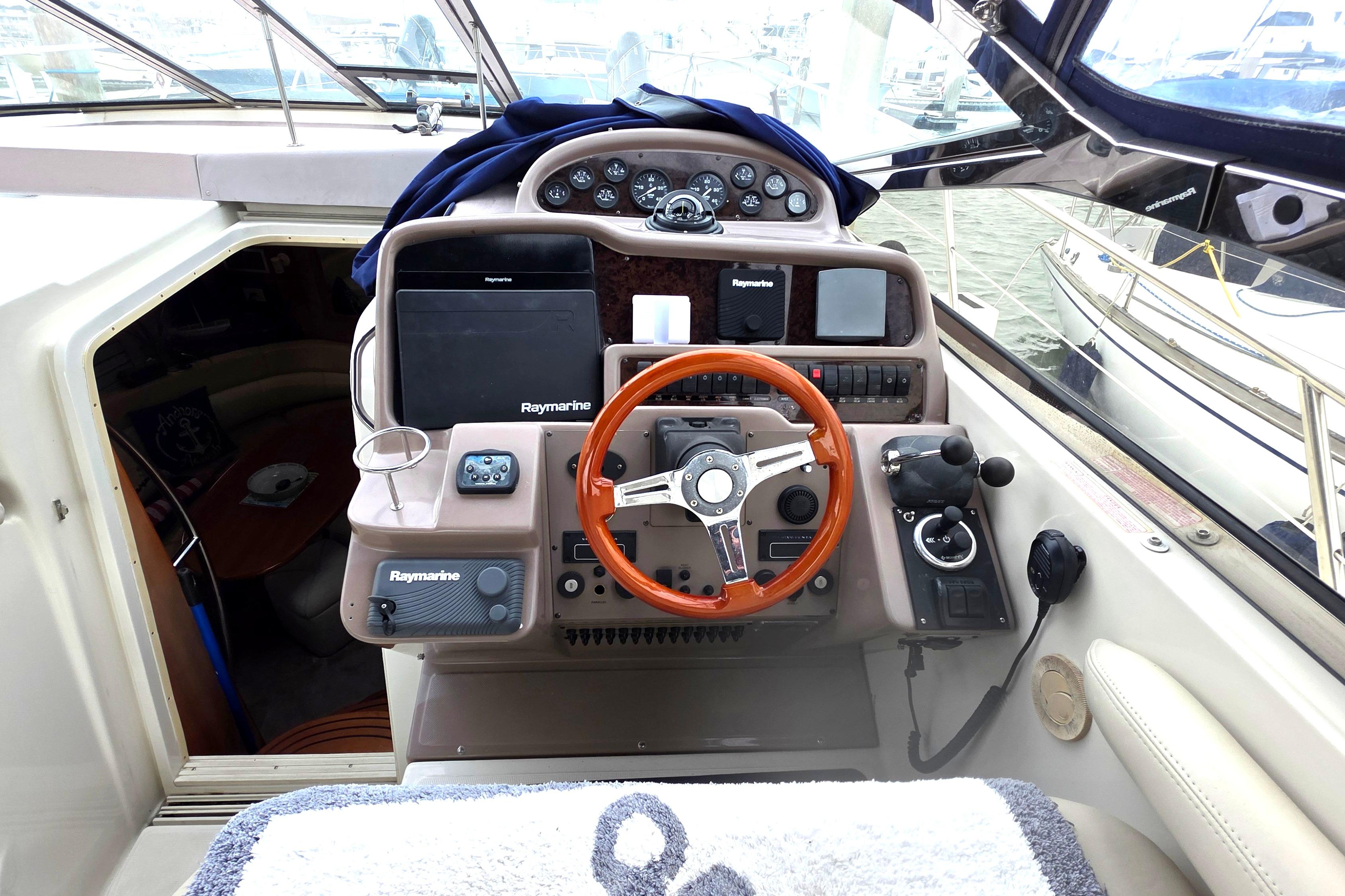 2002 Regal Commodore 4260 yacht cockpit with steering wheel and navigation equipment.