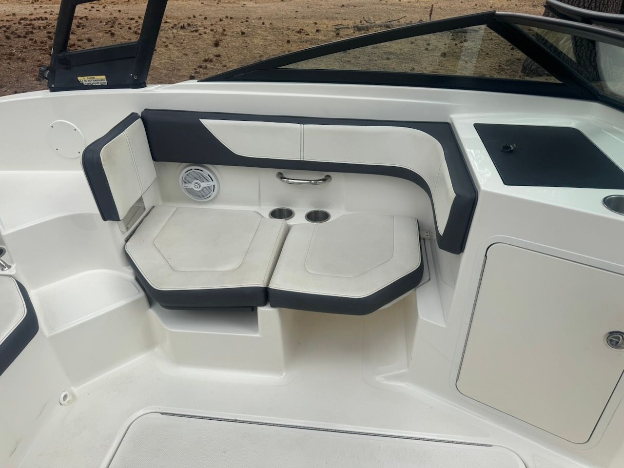 Interior view of a 2016 Sea Ray SPX 190 Outboard with white and black seating.