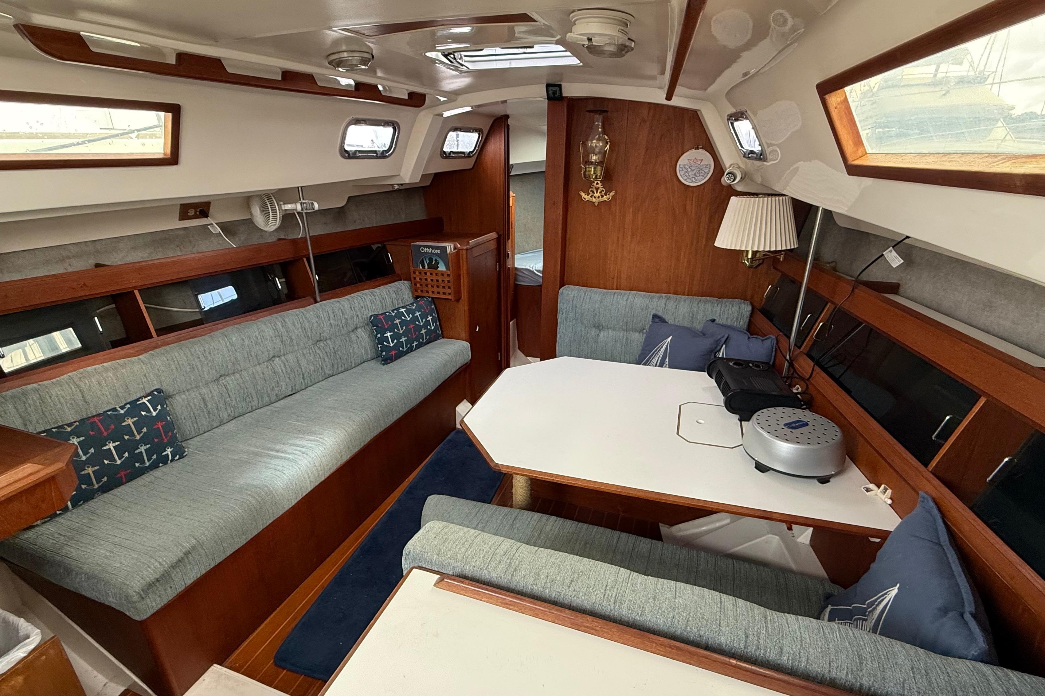 1984 Hunter 31 sailboat interior with cozy seating and dining area.