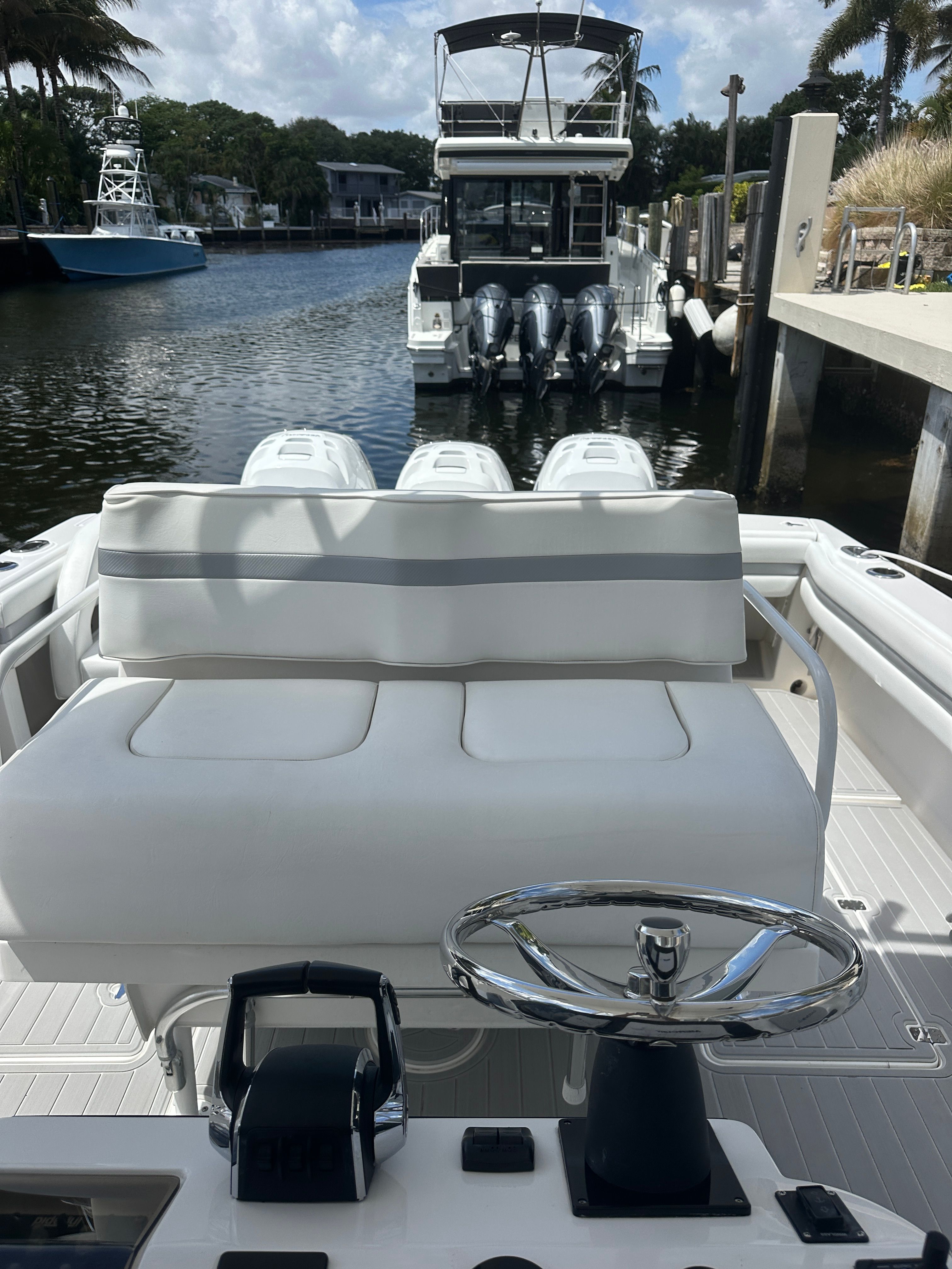 2004 Intrepid 377 Walkaround boat with helm and seating area.