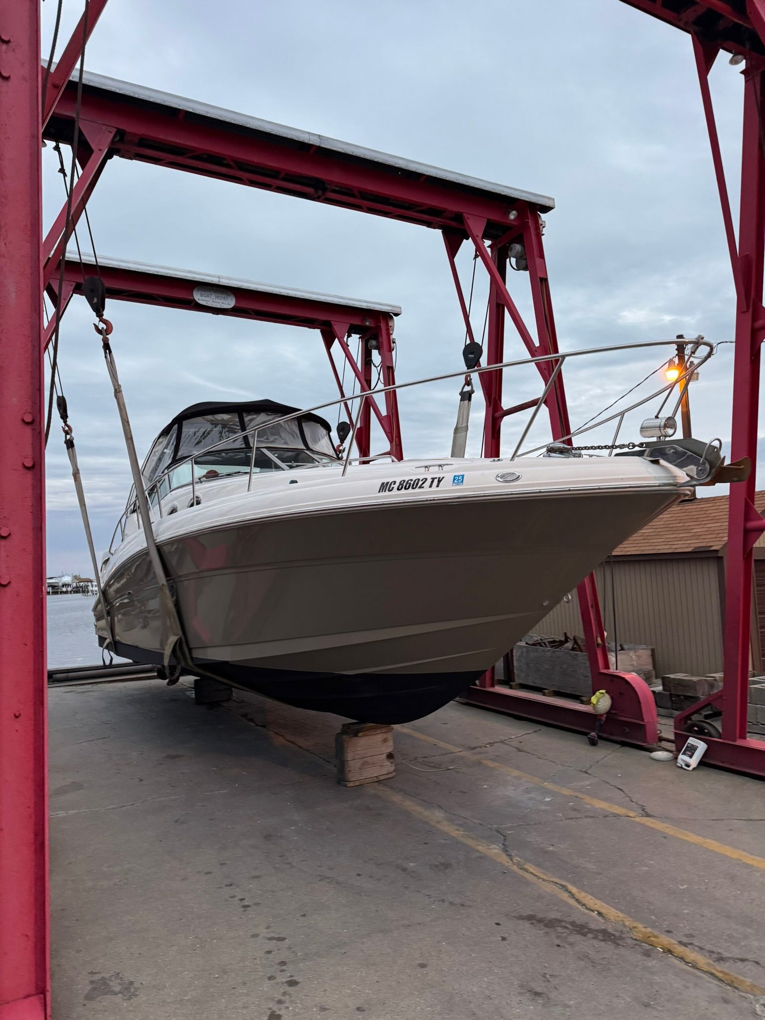 2007 Sea Ray 340 Sundancer on a boat lift at the harbor.