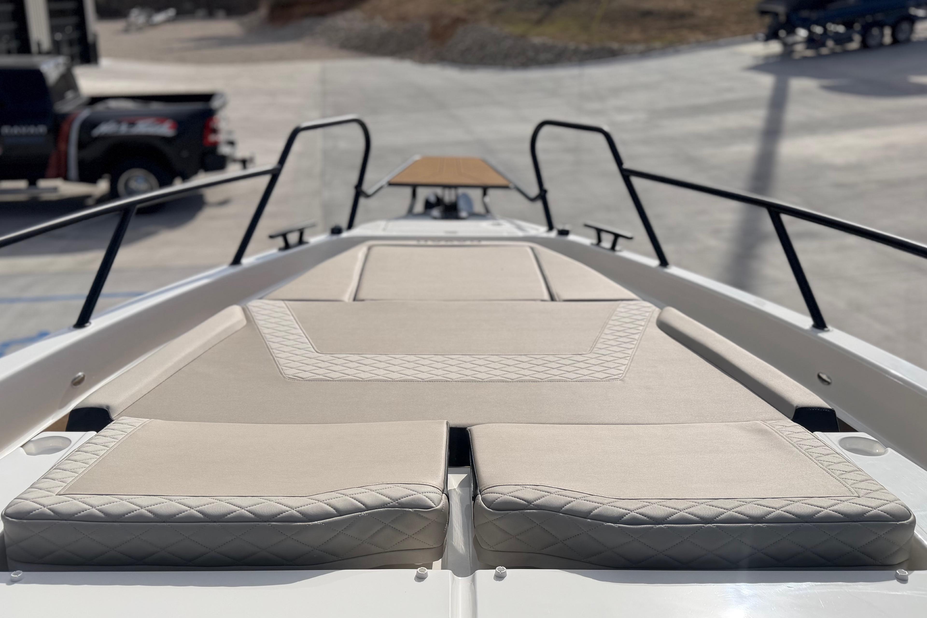 Luxurious deck of 2026 Navan S30 boat with beige cushioned seating.