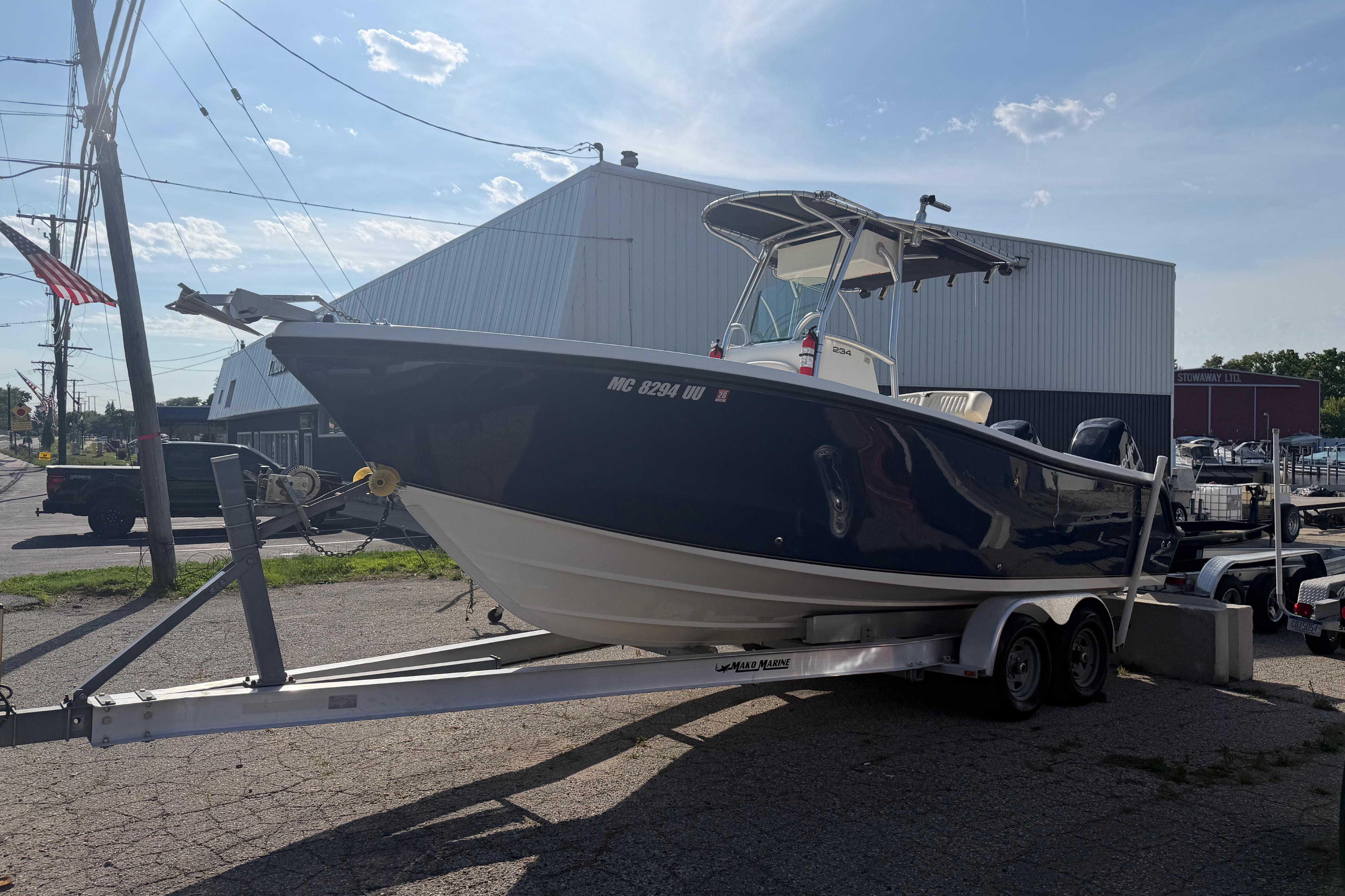 A 2007 Mako 234 Center Console on a trailer in front of a building.
