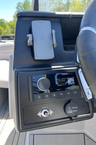2024 Moomba Max boat dashboard with control panel and phone holder.
