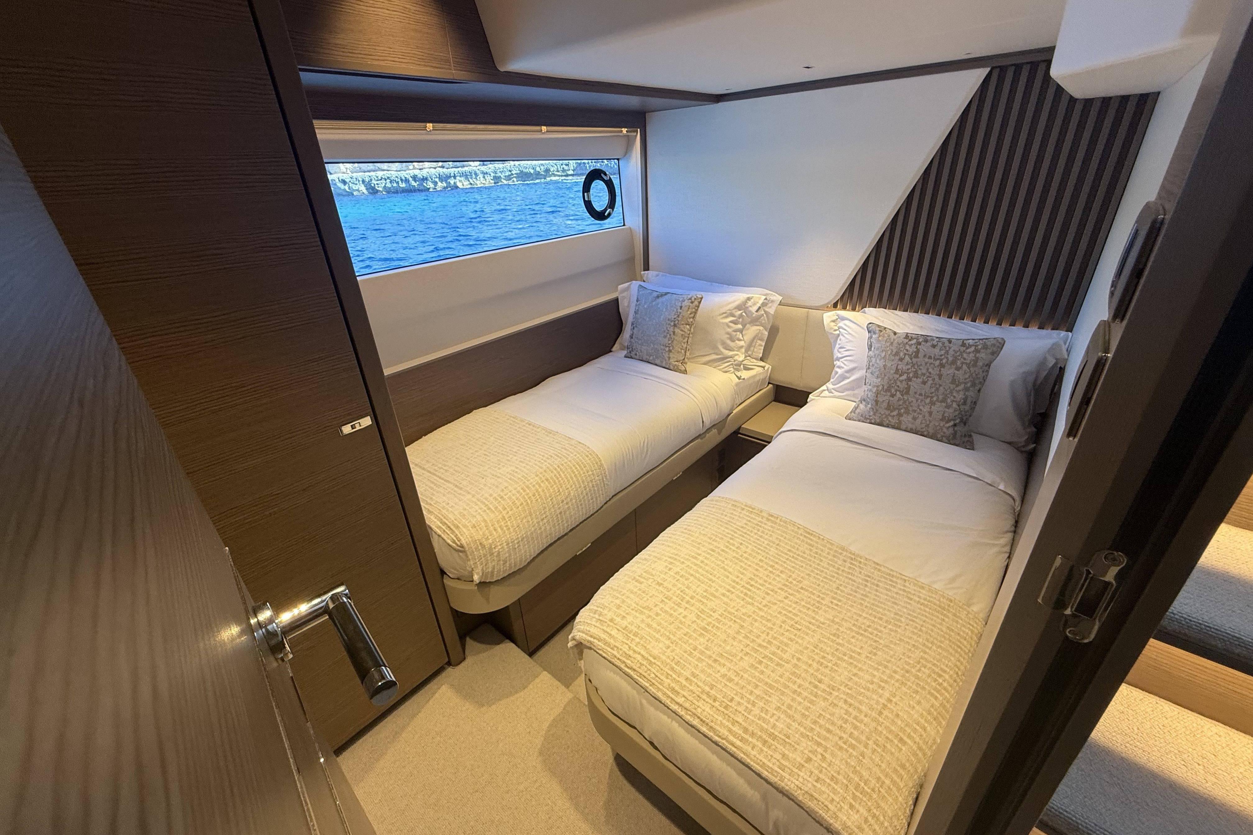 Luxurious twin cabin interior on 2025 Princess Y72 yacht with ocean view.
