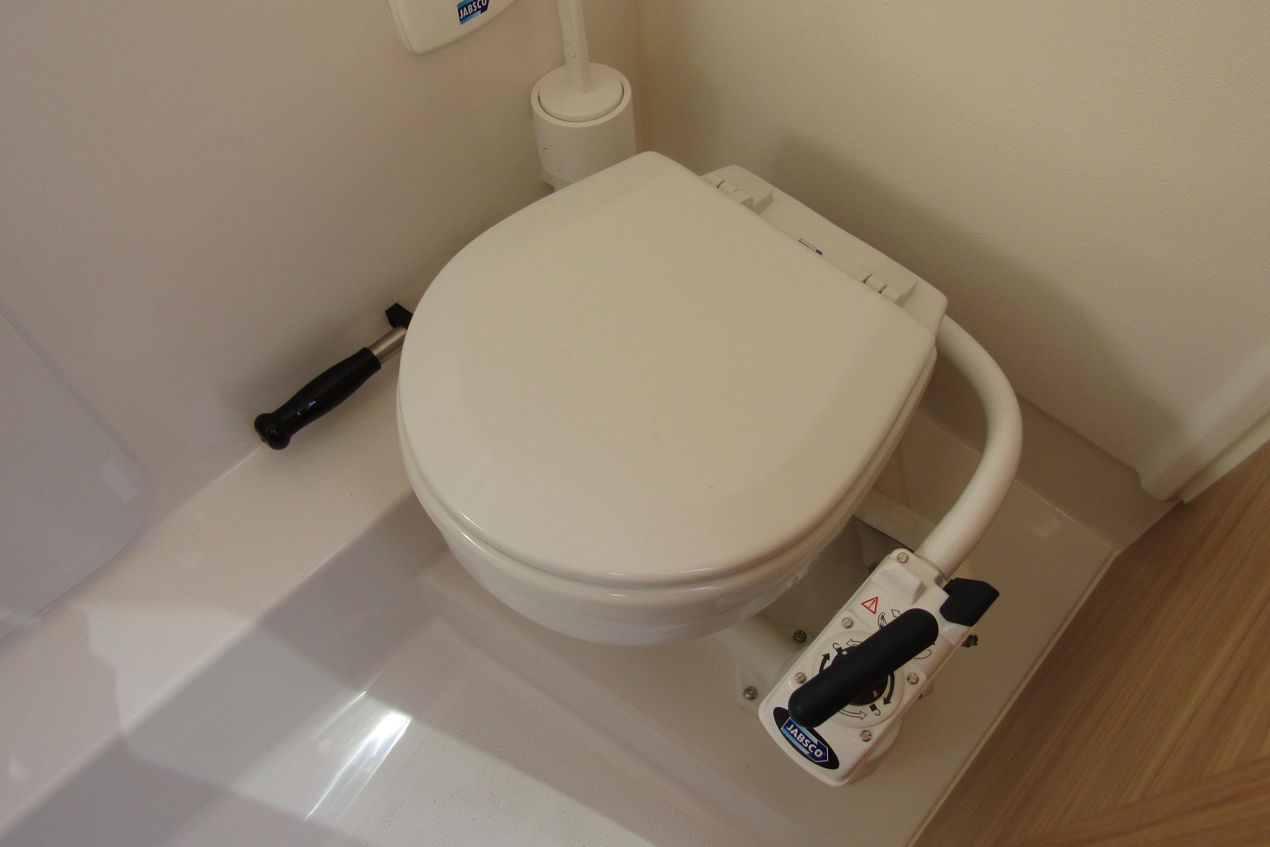 Boat toilet in Nimbus Tender 9, 2025 model, featuring manual flush handle.