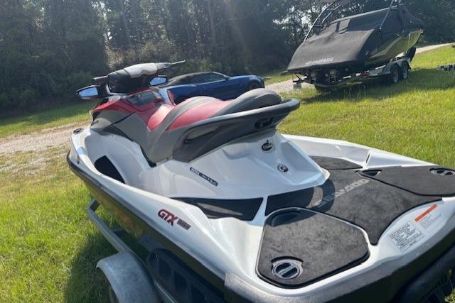 2010 Sea-Doo GTX 155 jet ski on grass, showcasing sleek design and vibrant colors.