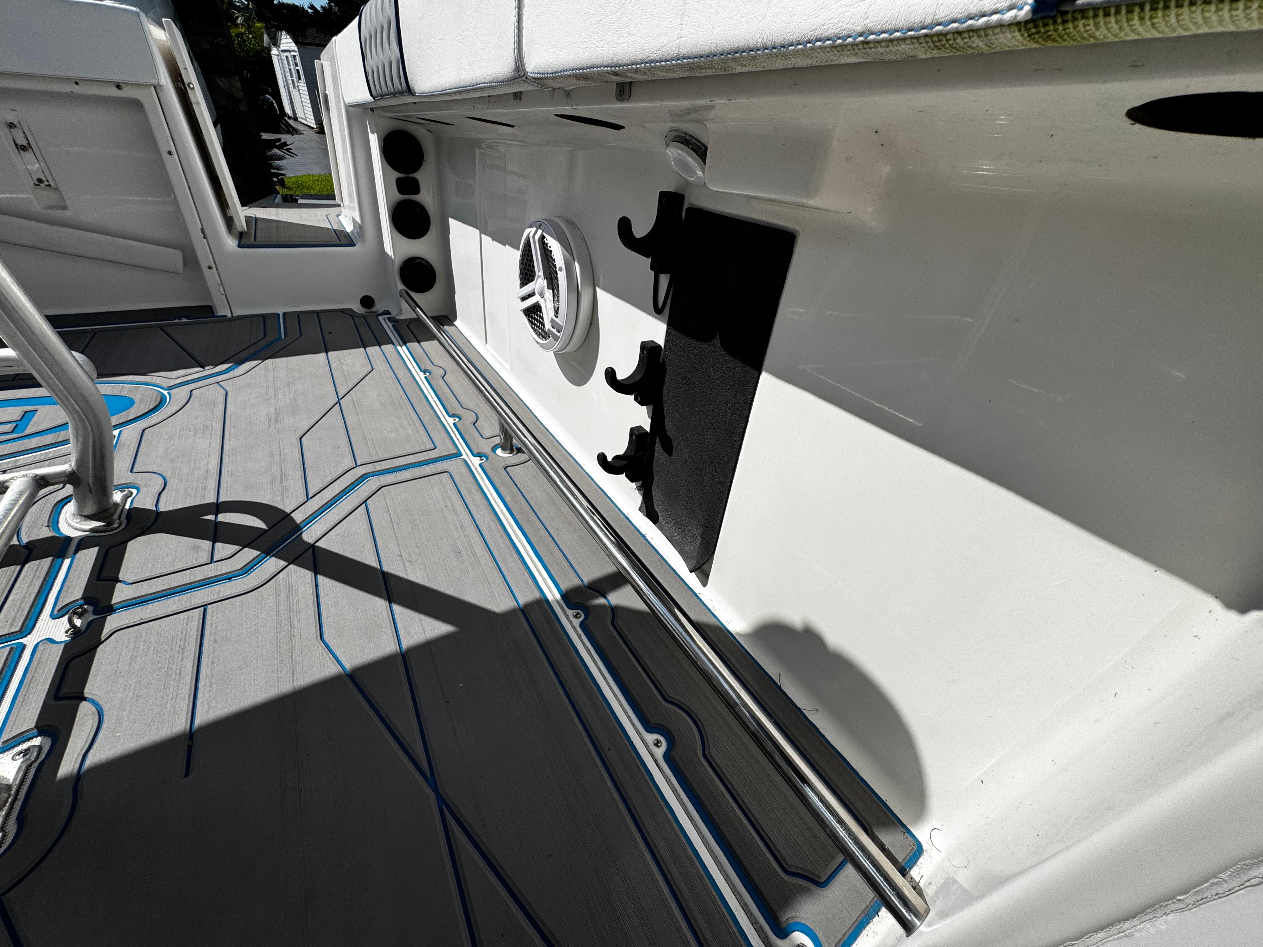 2004 Robalo R 260 boat interior with custom flooring and rod holders.