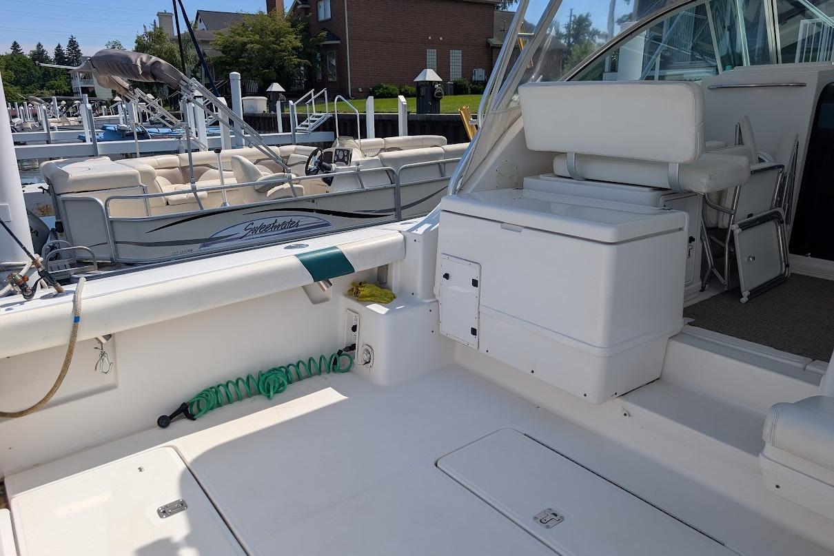 2000 Pursuit 3400 Express boat interior with seating and storage, docked at marina.