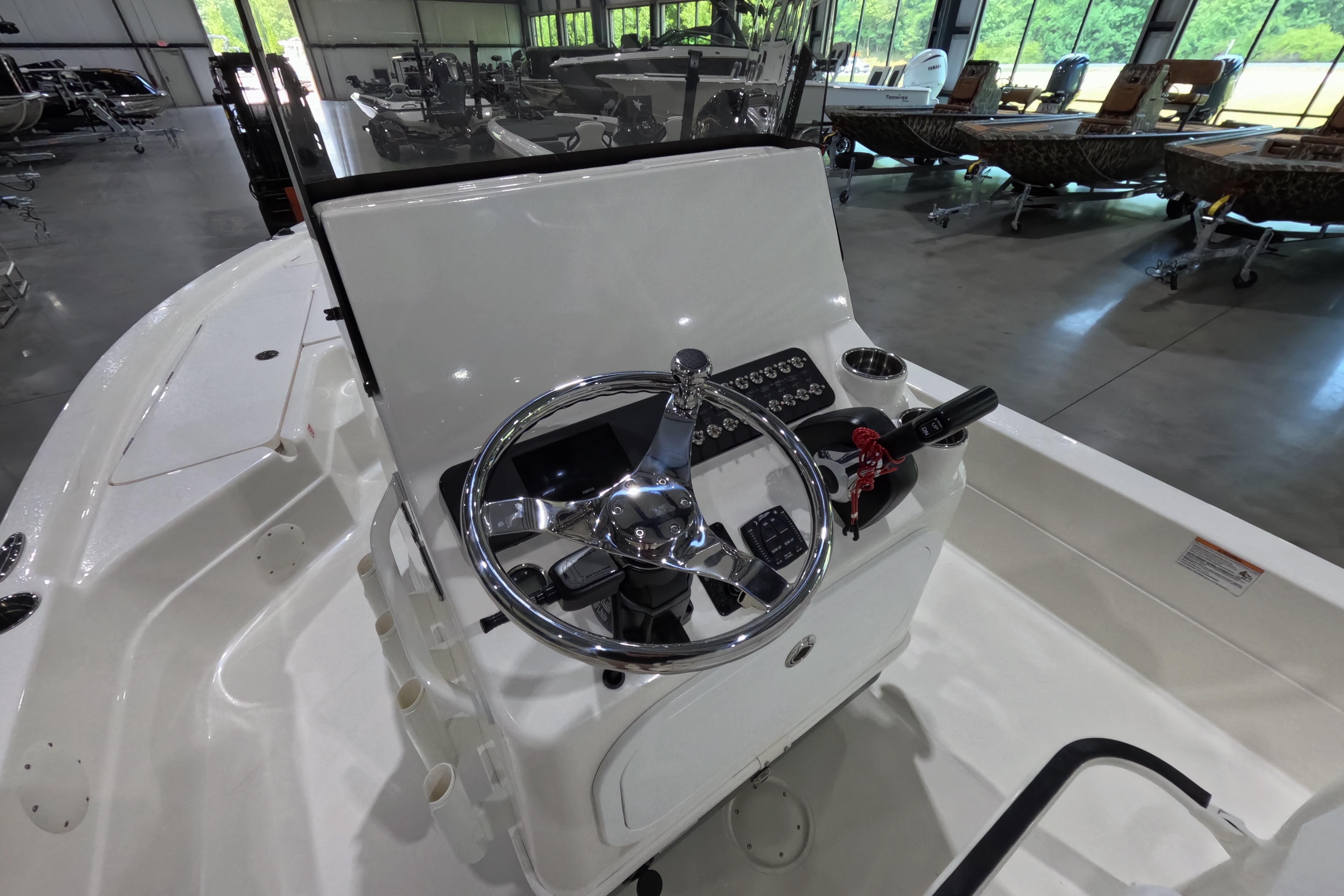 2026 Skeeter boat interior with steering wheel and control panel in a showroom.