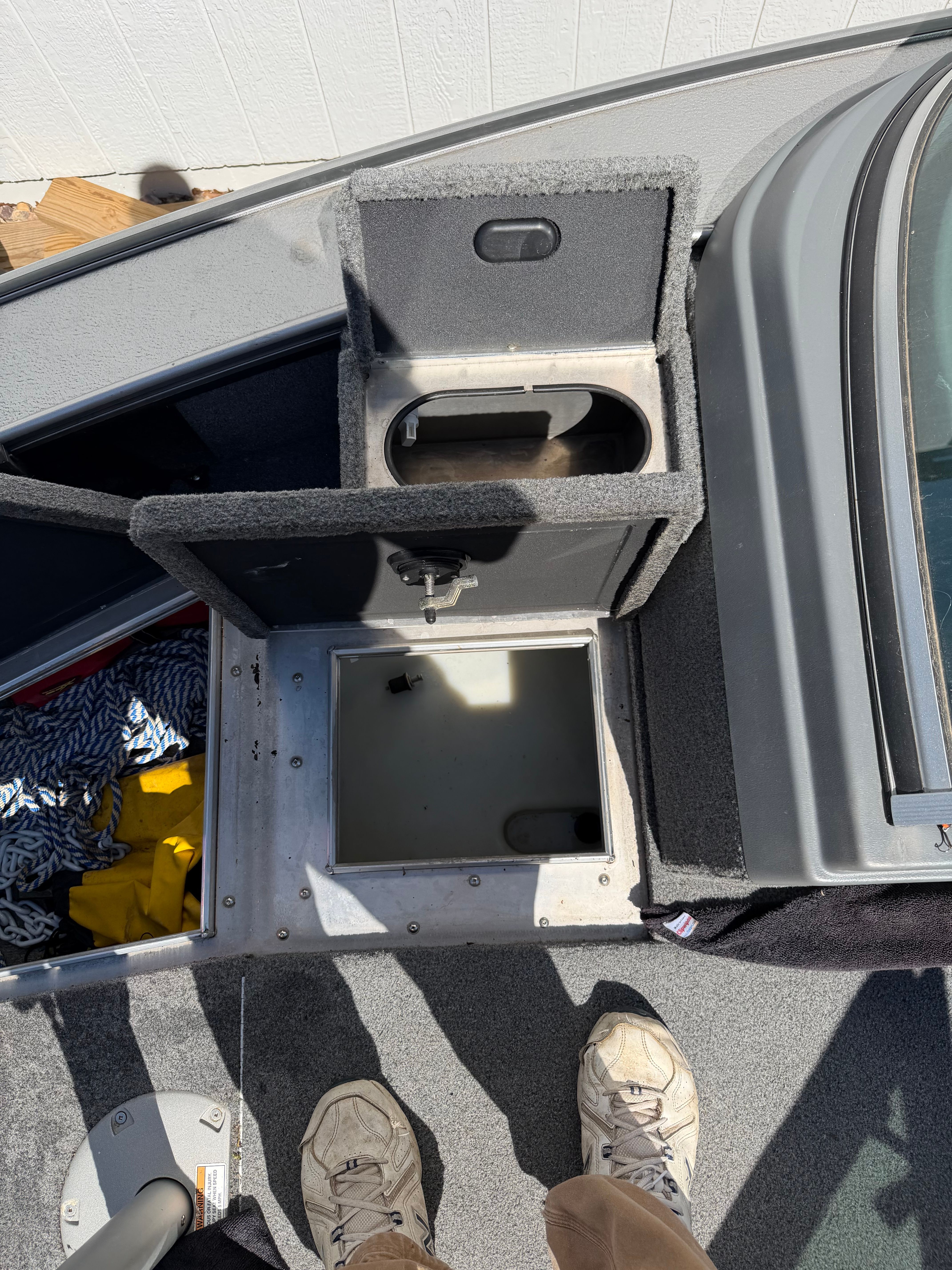 Interior view of a 2017 Lund Pro V 1975 boat with storage compartments.