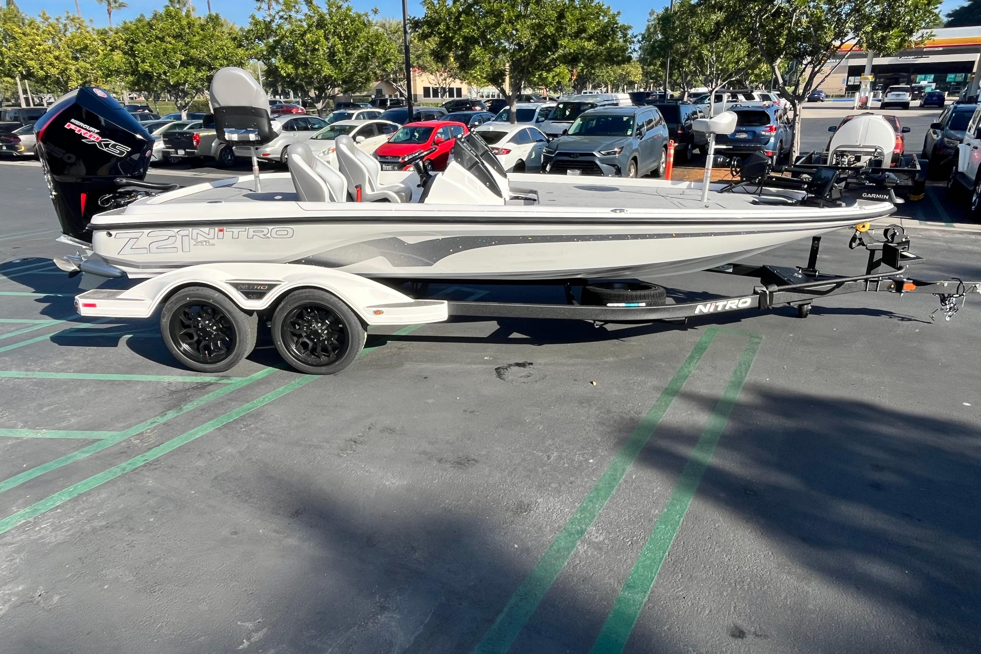 2026 Nitro Z21 XL Pro boat on trailer in parking lot, surrounded by cars.