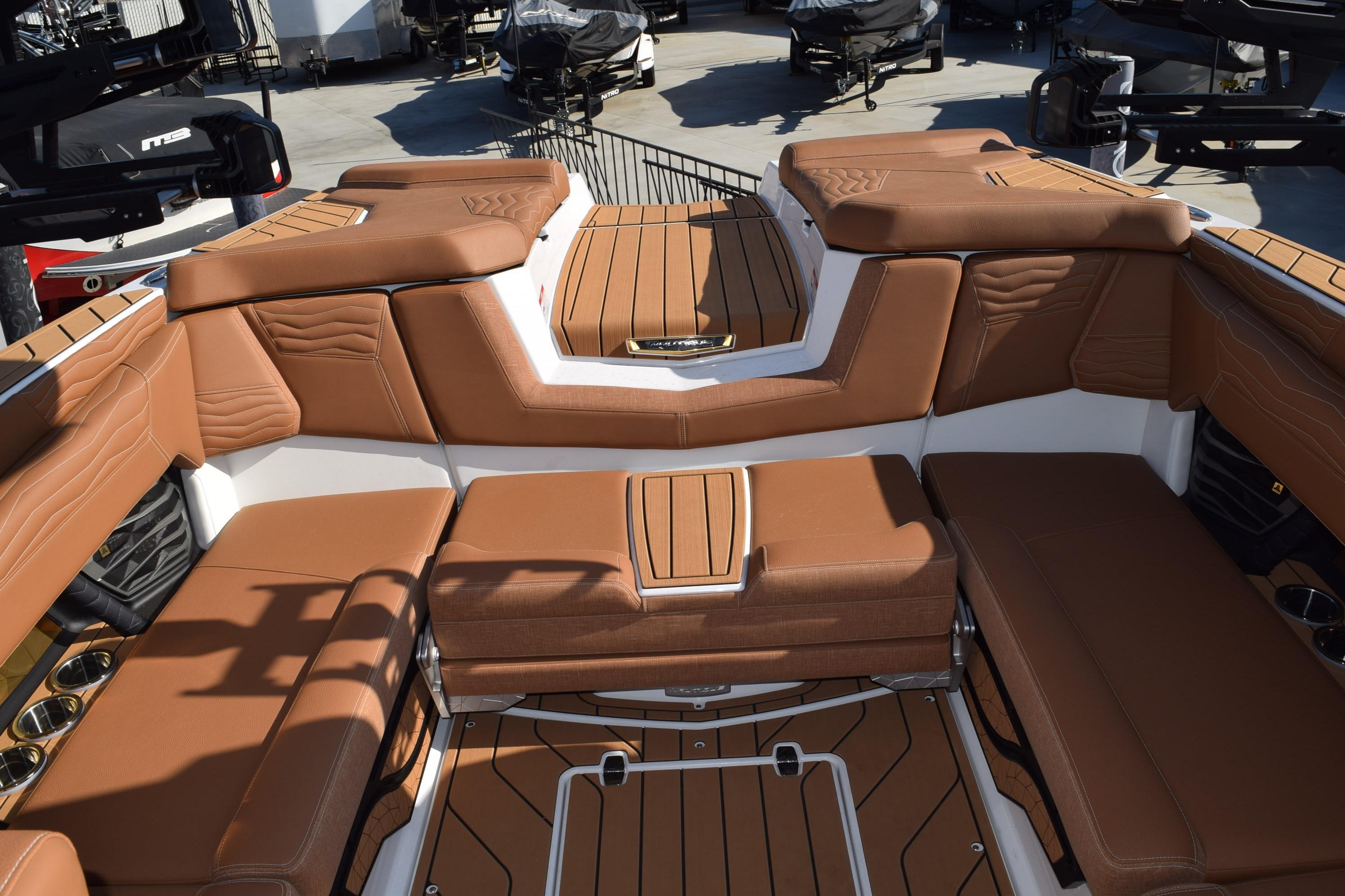 Luxurious interior of 2026 Nautique Super Air Nautique G23 boat with brown seating.