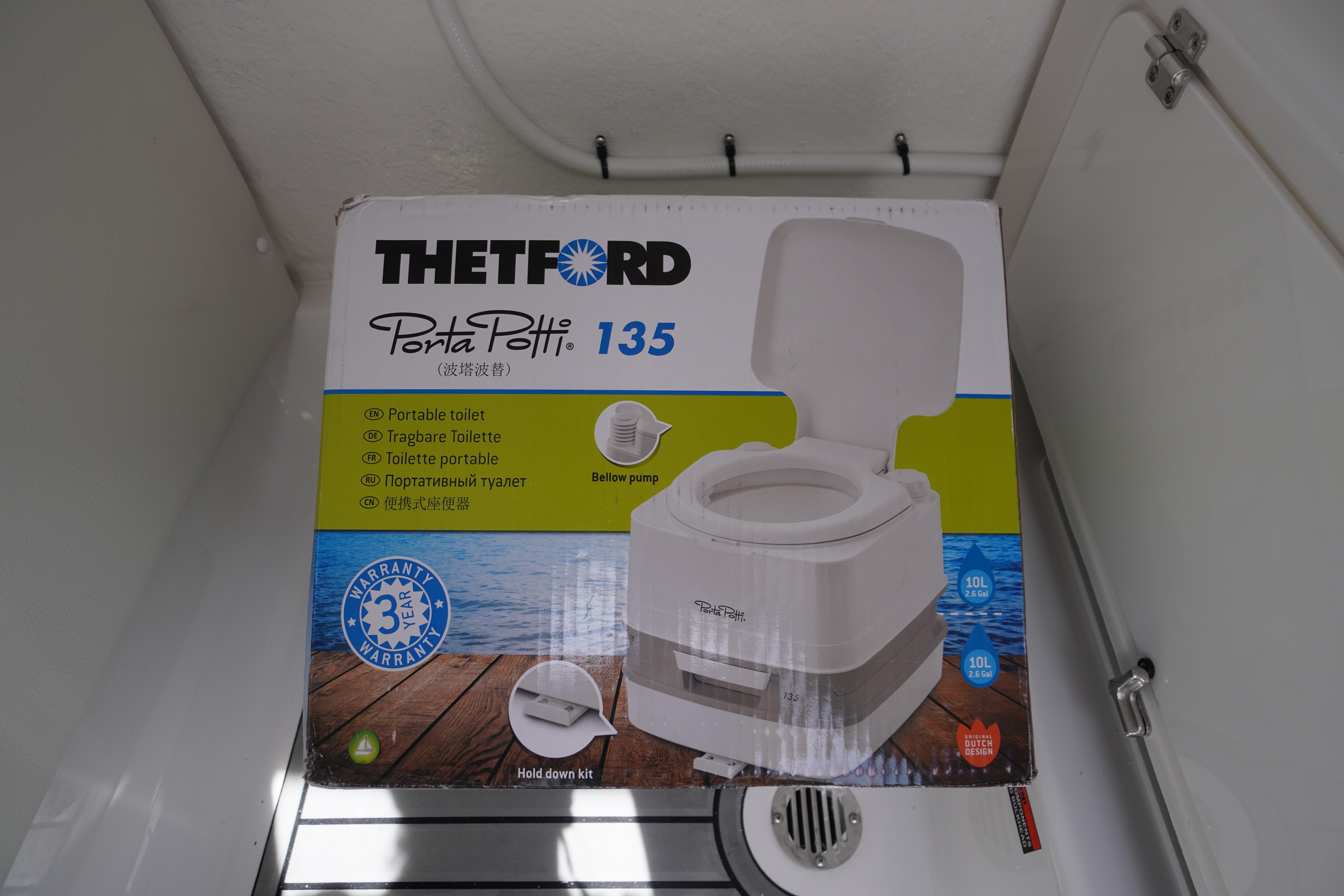 Box of Thetford Porta Potti 135 portable toilet inside 2026 Tidewater 232 SS boat.