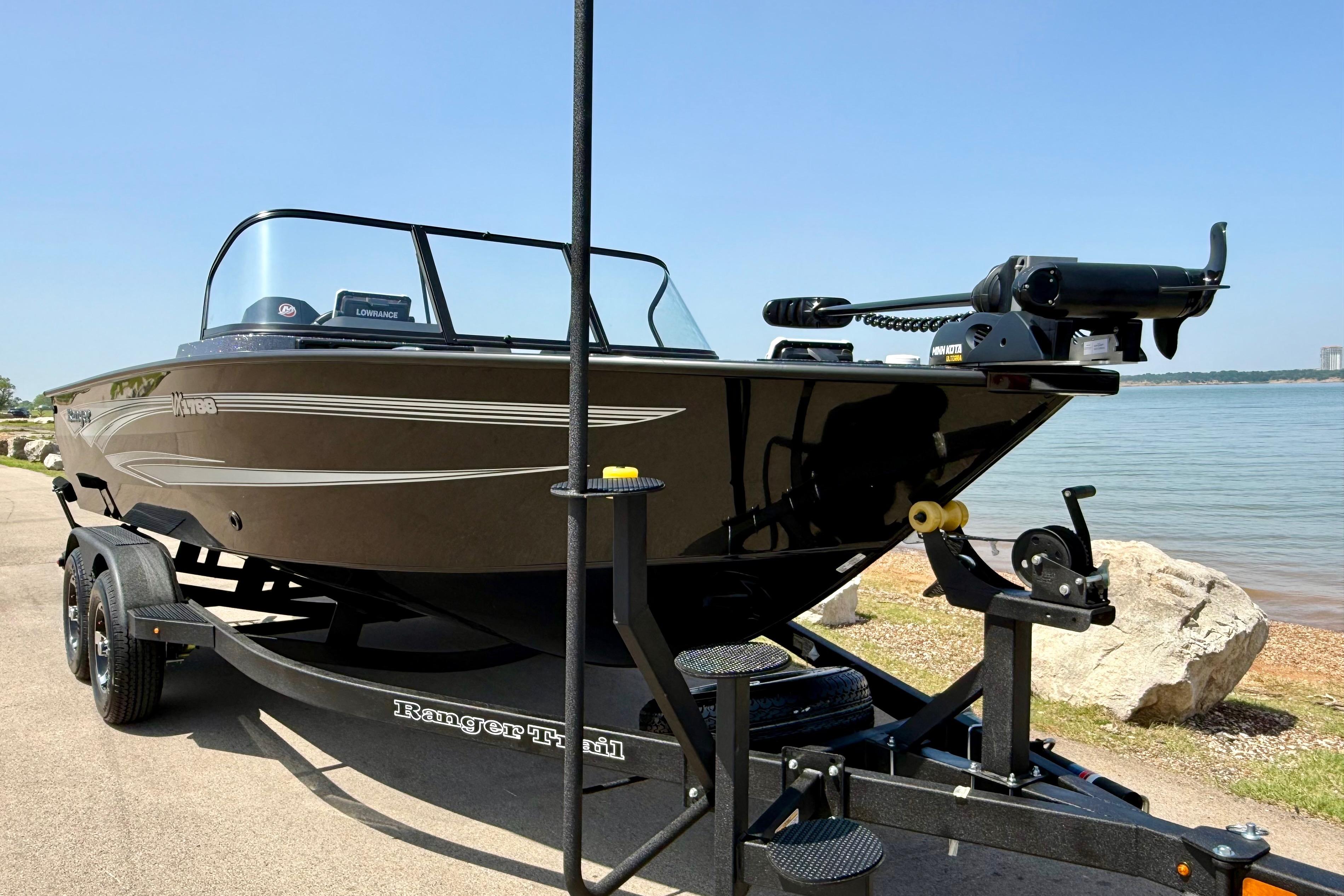 2026 Ranger VX1788 WT boat on trailer by a lake, clear sky background.