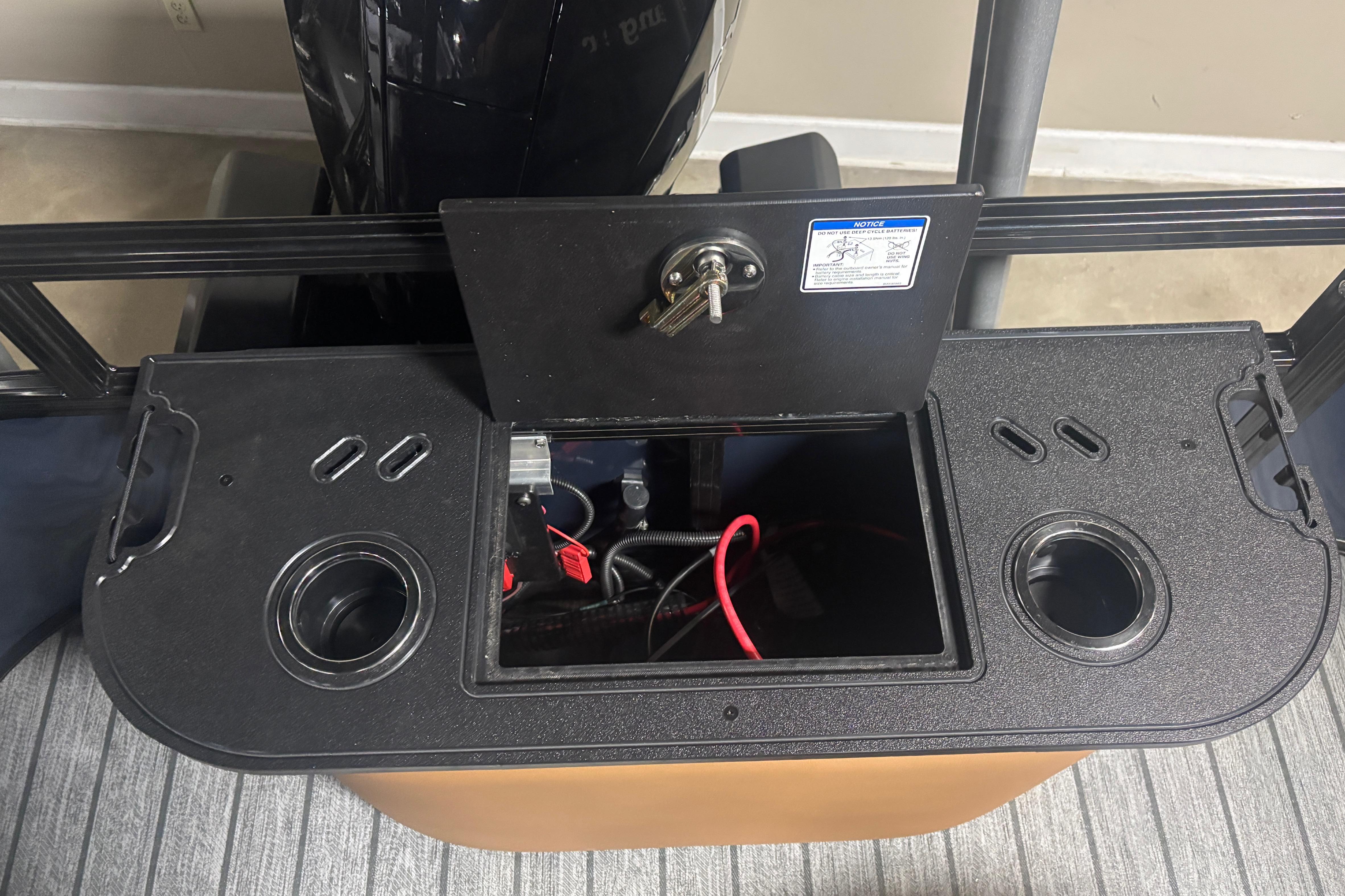 Control panel of a 2026 Ranger 223F boat with open storage compartment.