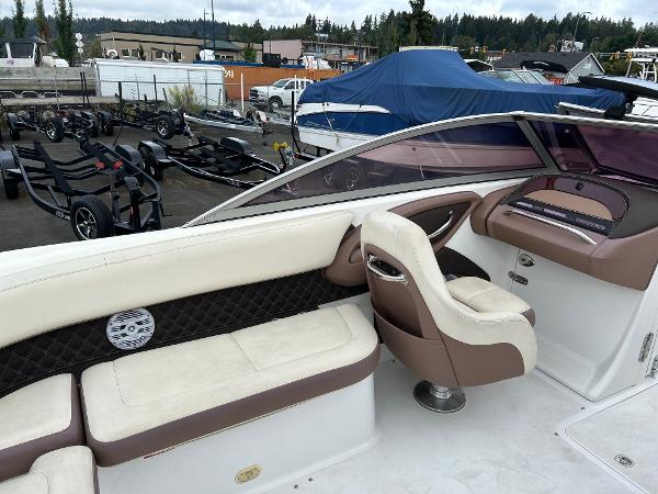 2010 Cobalt 262 boat interior with beige seating and dashboard, parked in a marina.