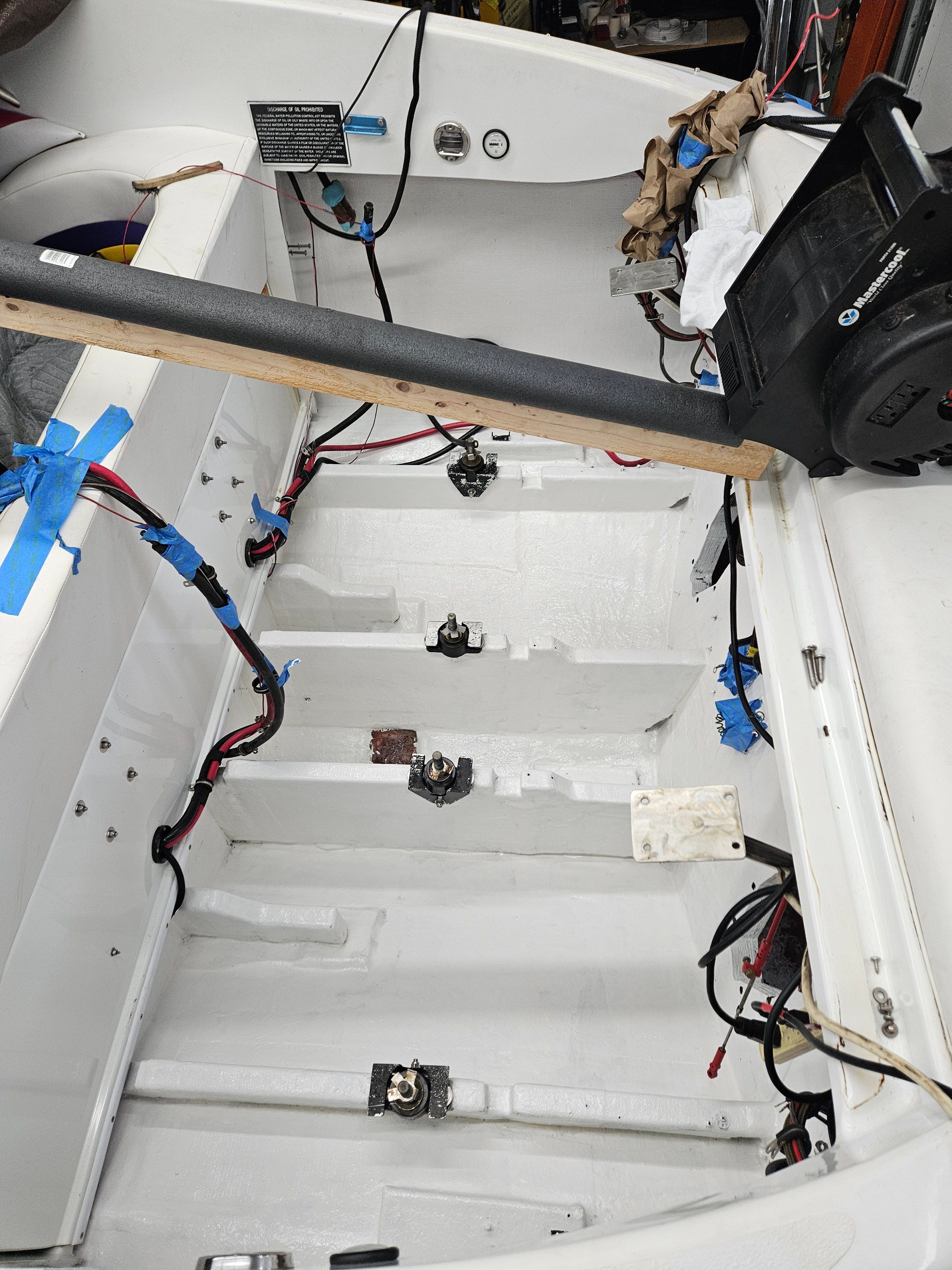 The image shows the engine compartment of a 1996 Baja 302 Boss. Wires and mounts are visible.