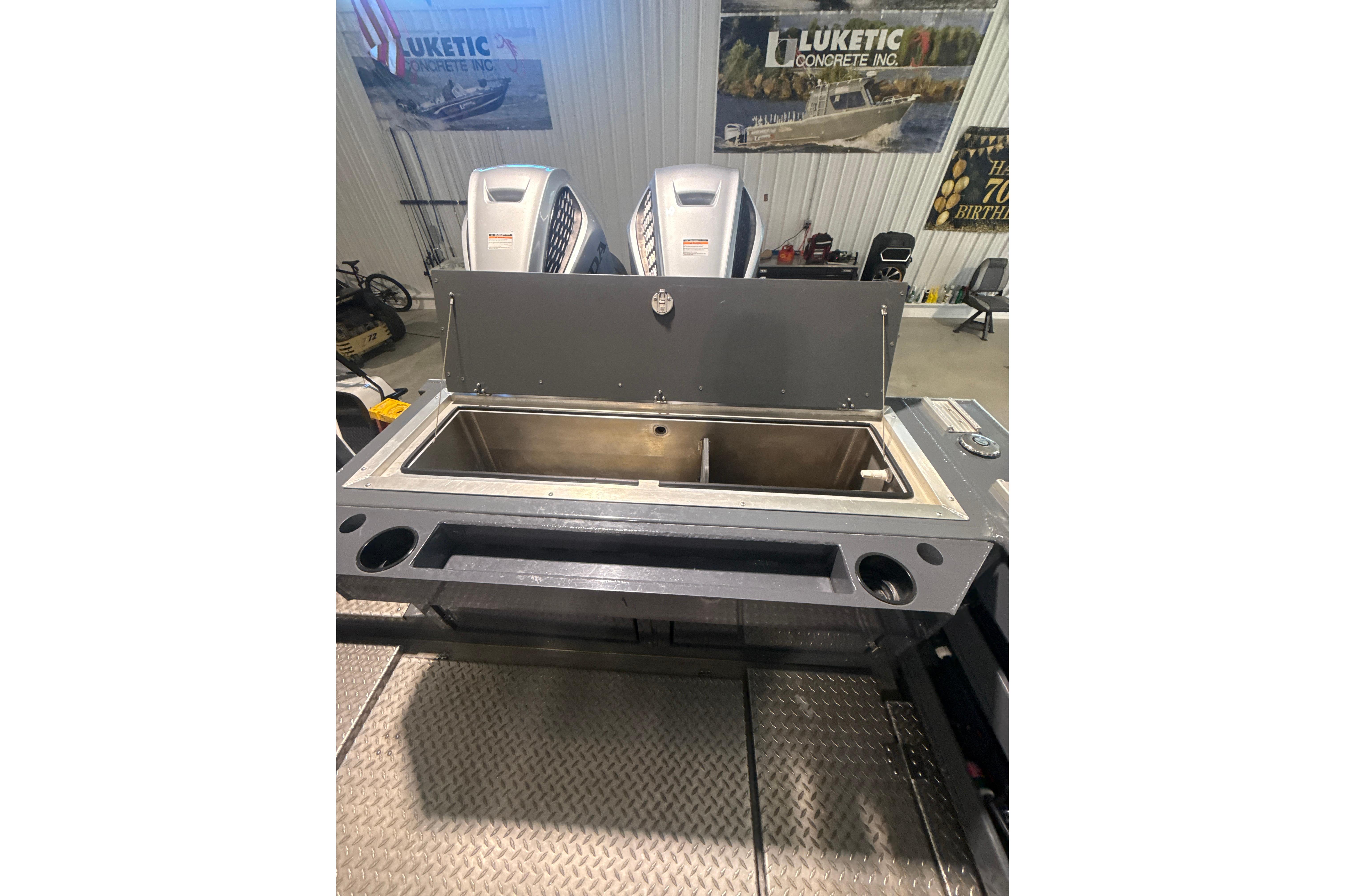 2022 Hewescraft 270 Alaskan Hardtop boat interior with open storage compartment.