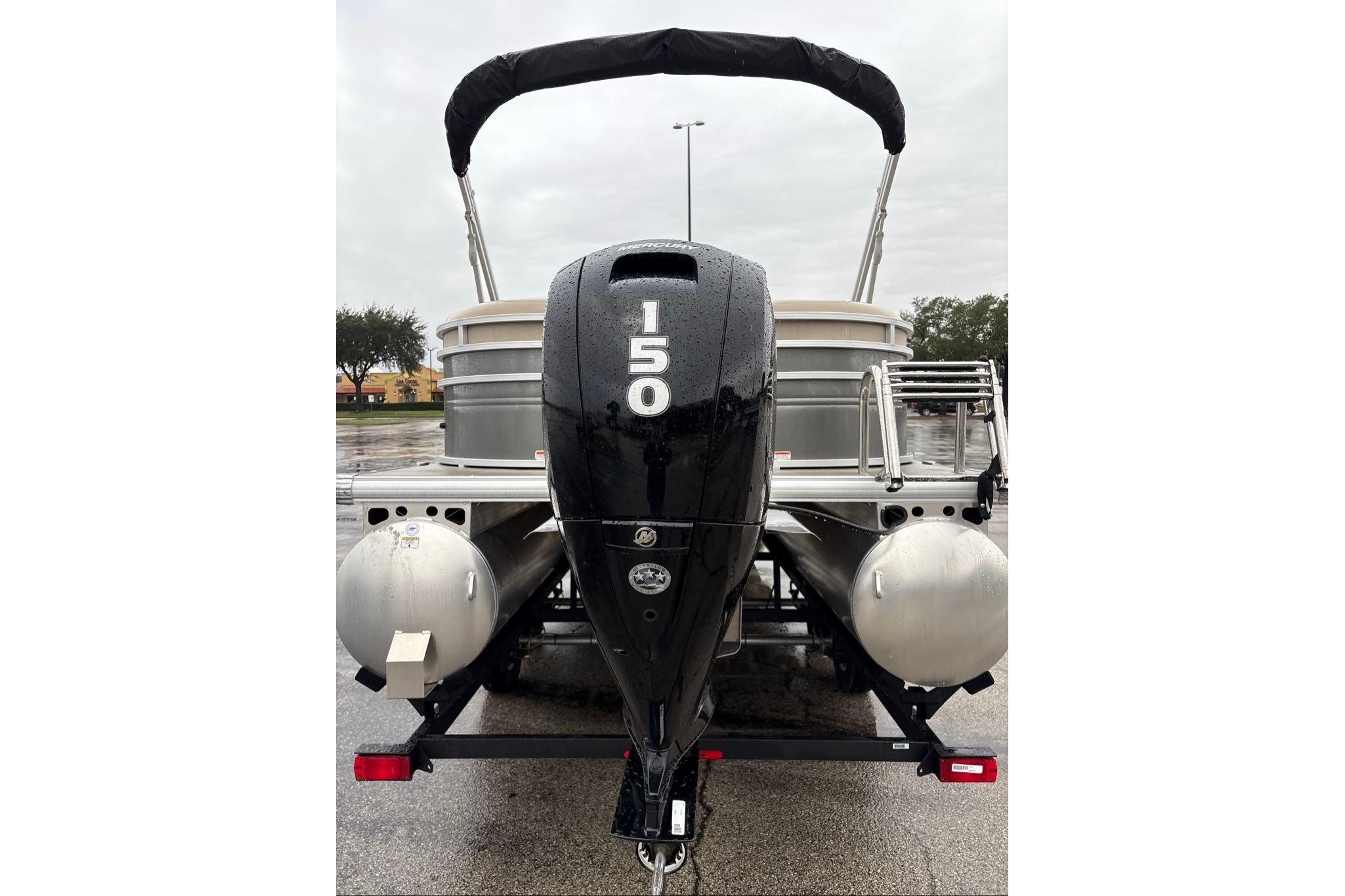 2024 Sun Tracker Party Barge 24 DLX with 150 HP engine, rear view.