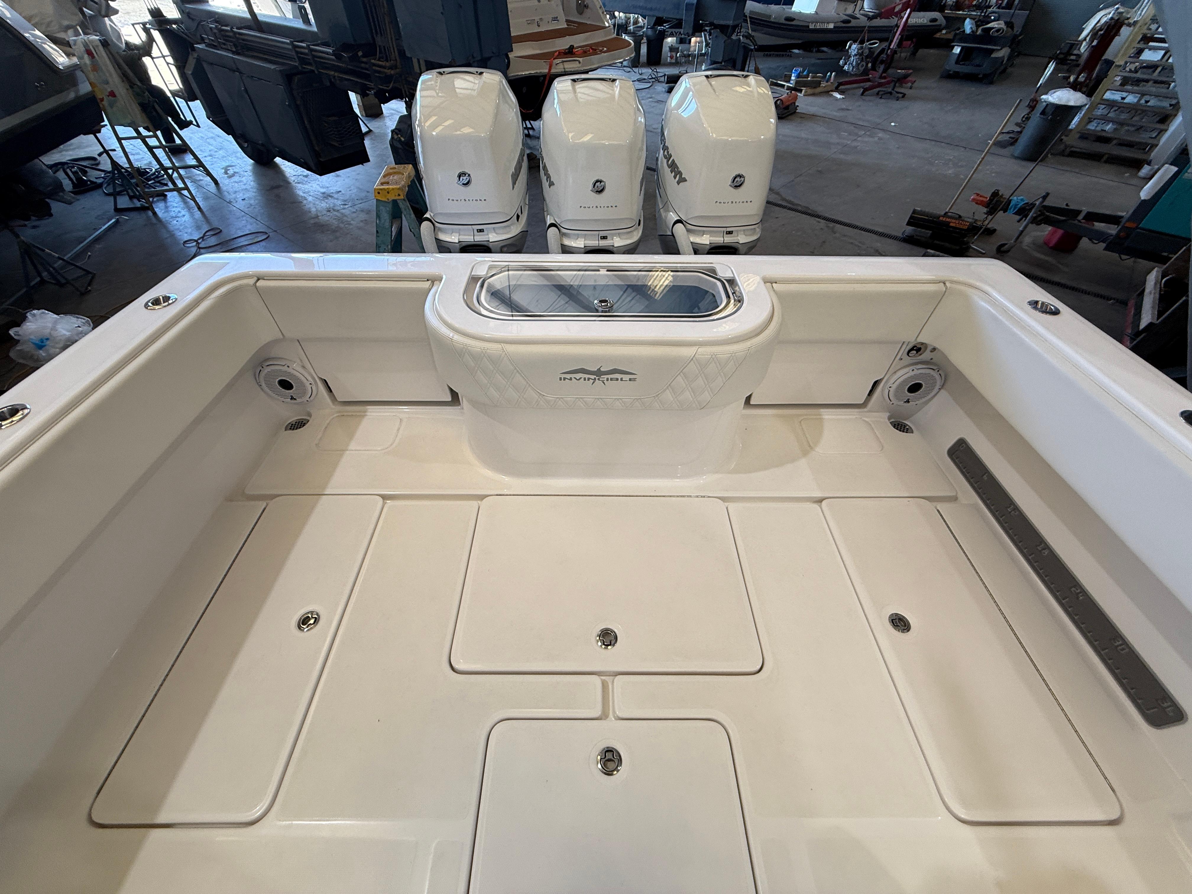 2022 Invincible 39 Open Fisherman boat deck with triple outboard engines.