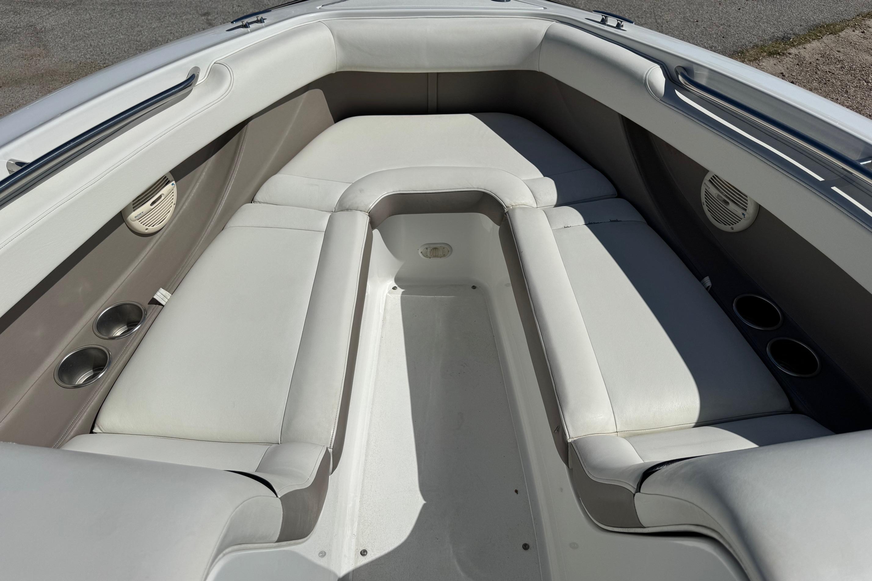 Interior seating of a 2005 Cobalt 240 boat, featuring white cushioned seats.