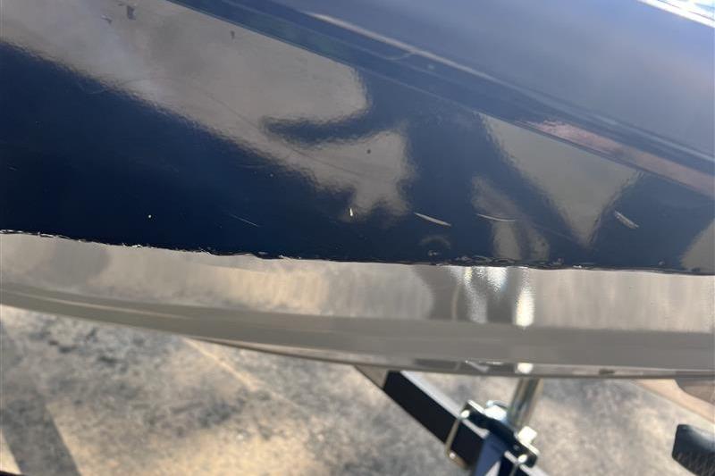 Close-up of 2021 Tracker Pro Team 175 TXW boat hull with visible scratches.