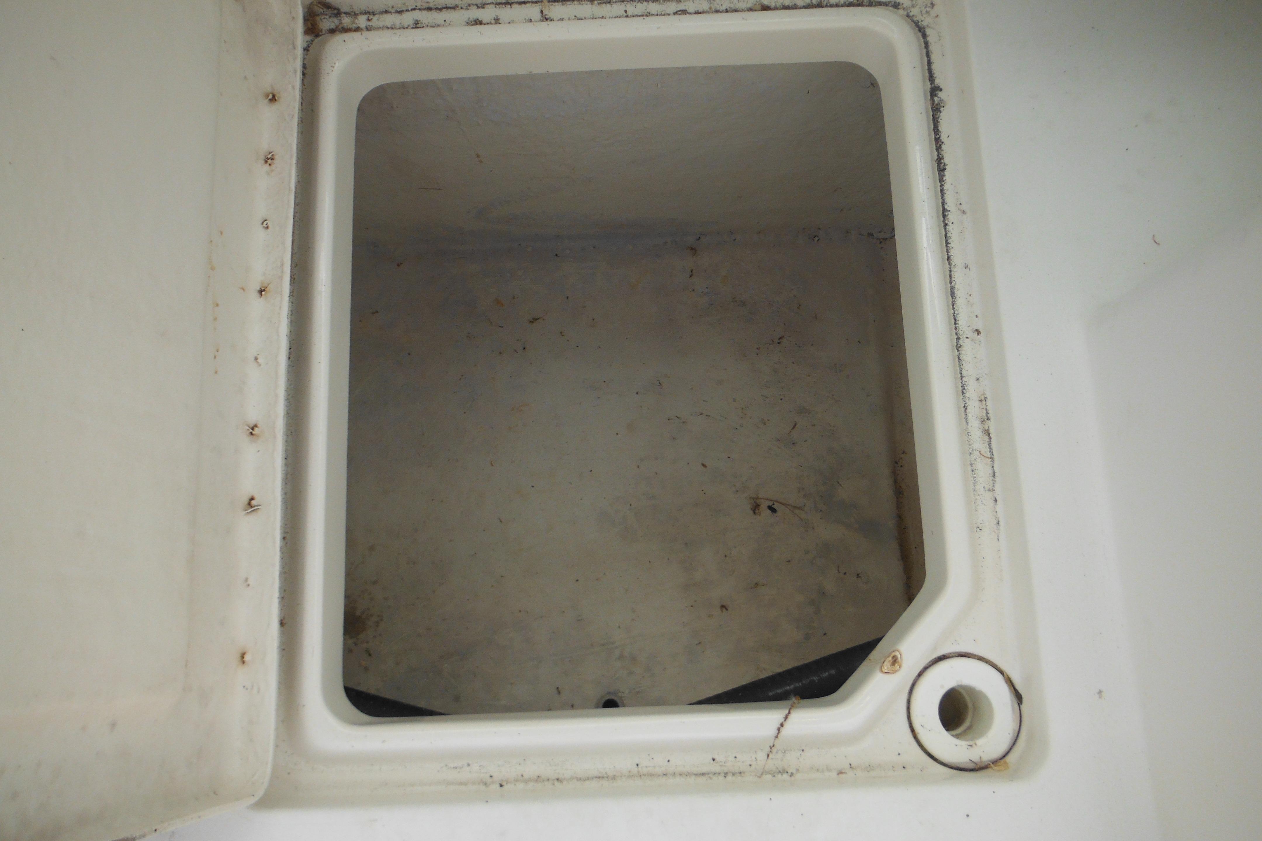 Open storage compartment on a 2005 Seaswirl Striper 2101 Walkaround O/B boat.