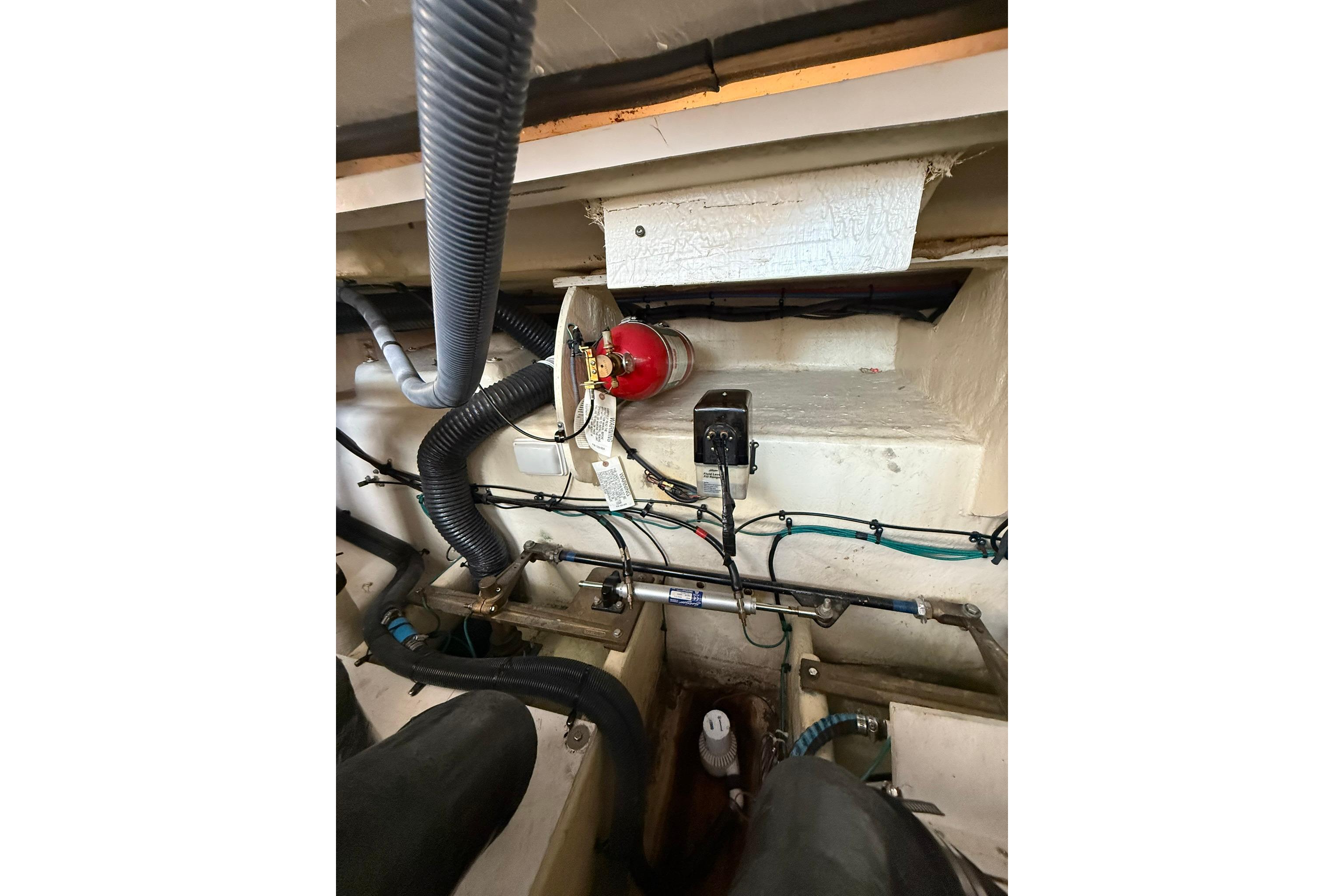 Engine compartment of a 2009 Sea Ray 350 Sundancer with hoses and wiring visible.