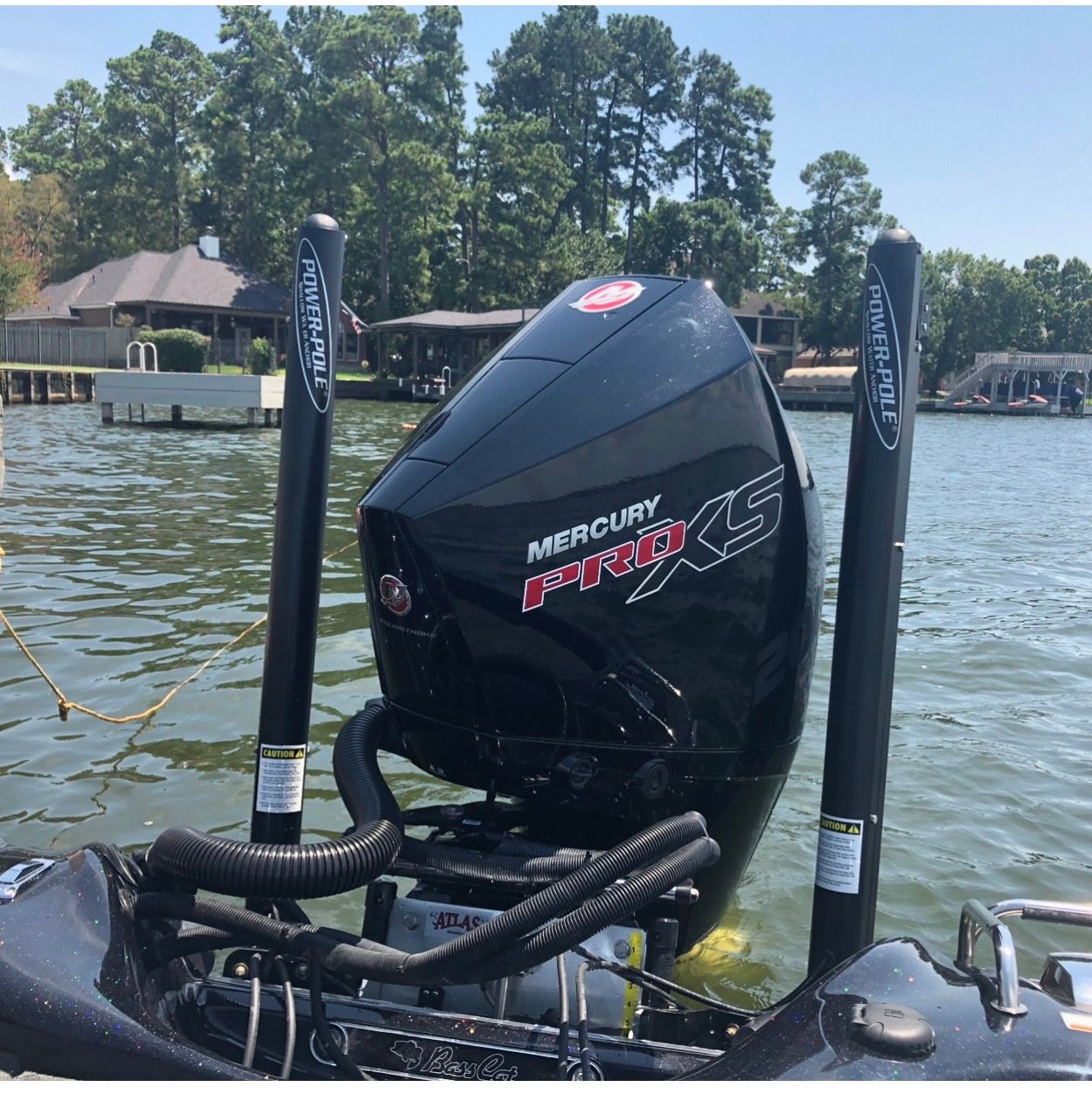 A Mercury Pro XS outboard motor on a Bass Cat Pantera II boat on a lake.