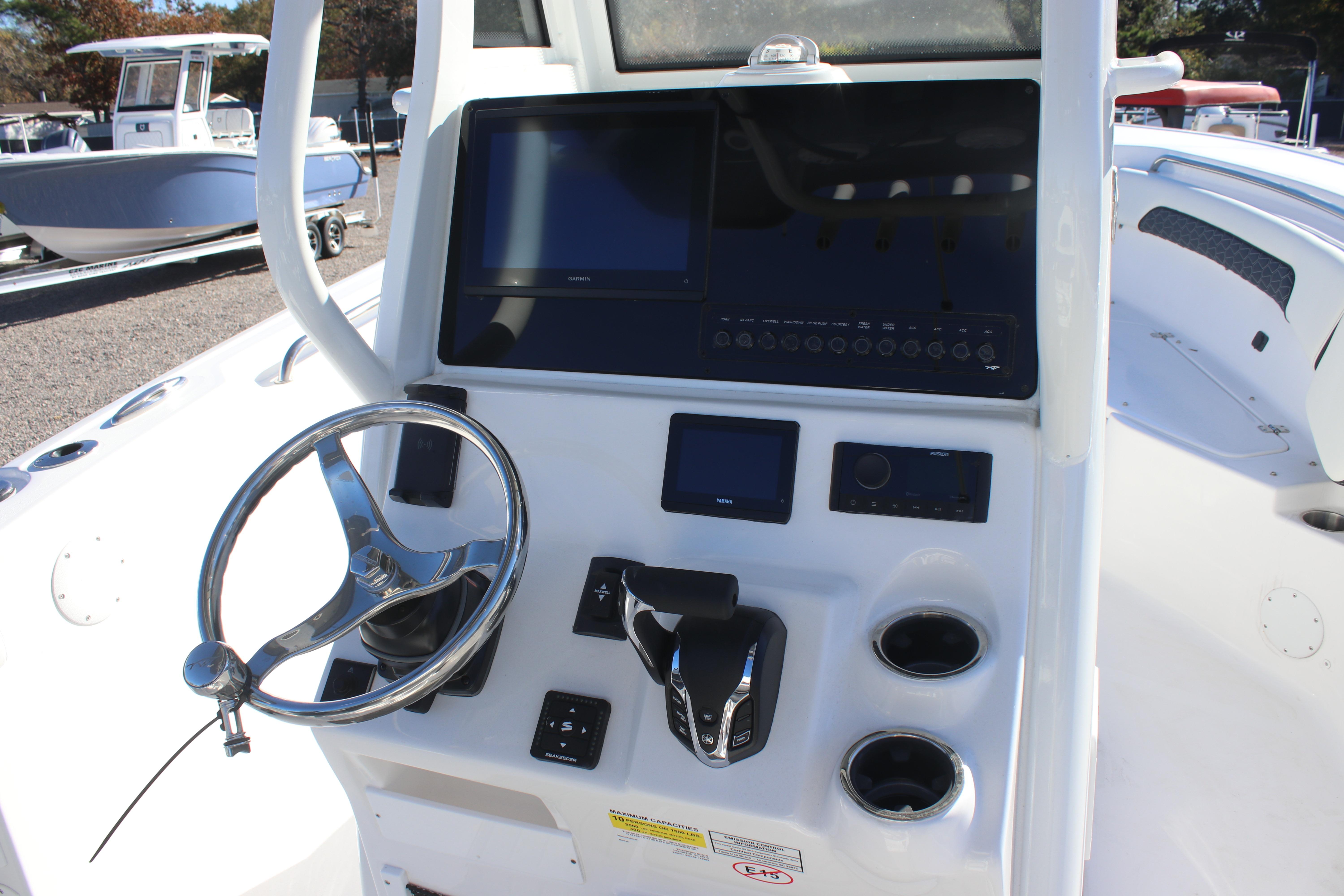 2026 Tidewater 232 CC Adventure boat console with steering wheel and navigation controls.