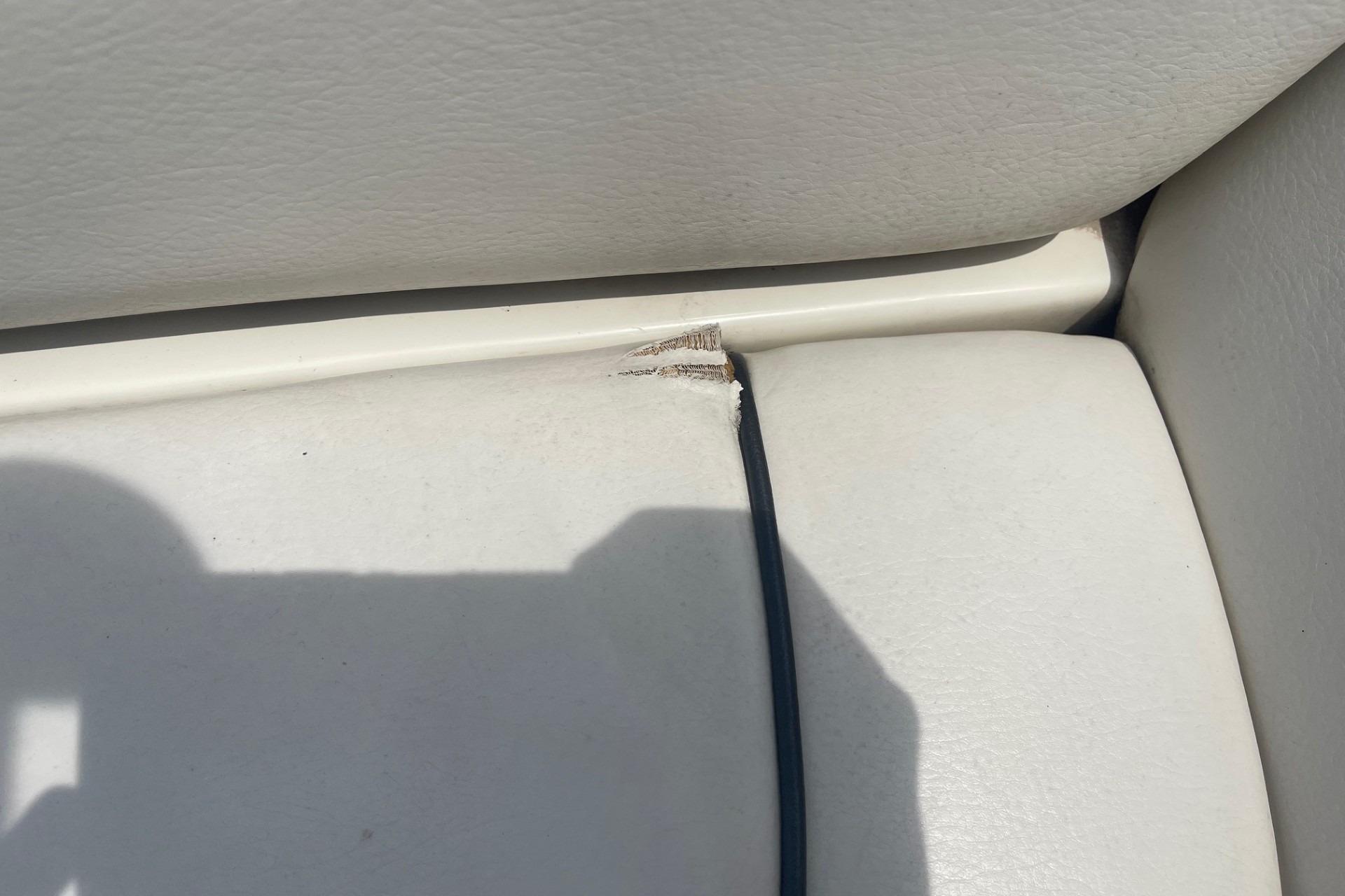 Torn upholstery on 2010 Sea Ray 230 Bow Rider Select boat seat.