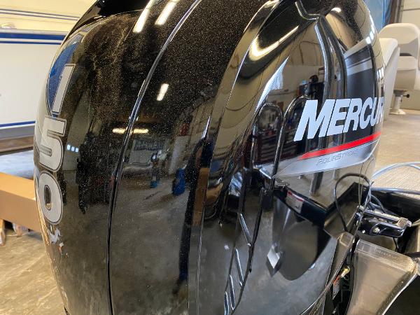 Close-up of a Mercury 150 outboard motor in a workshop.